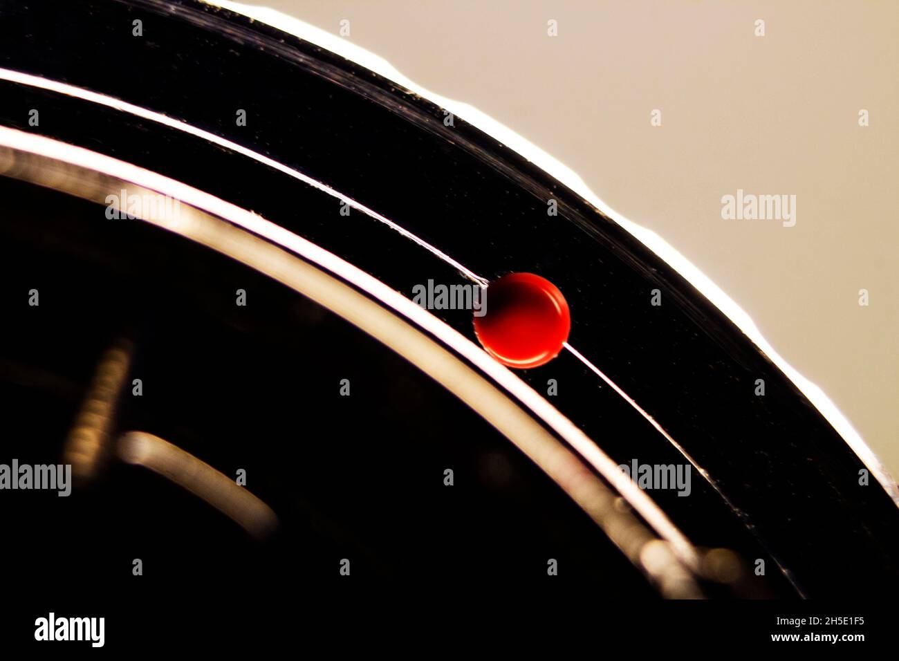 Macro shot of the red dot of a vintage full frame camera lens Stock Photo