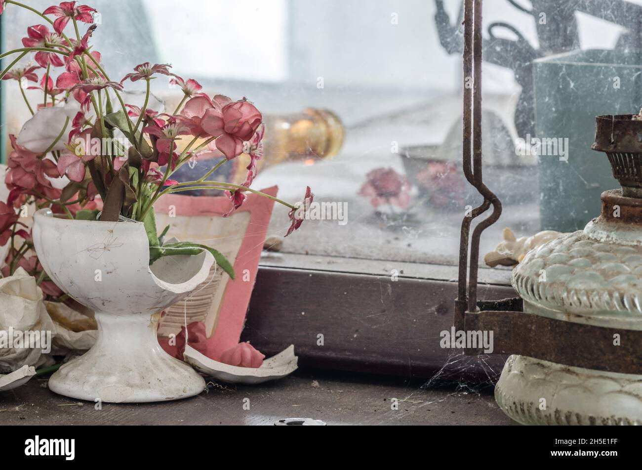 broken vase with flowers in an old house Stock Photo Alamy