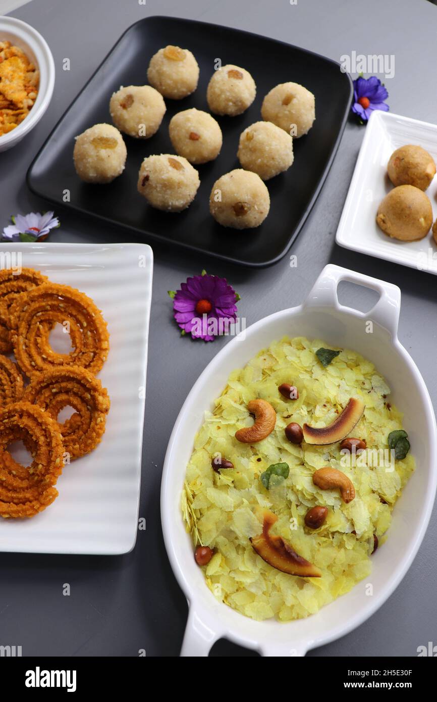 Indian festival food - Diwali Special sweet and salty snacks such as, Chakli, rava laddu, besan ladu, poha chivda, and corn mixture, Namkeen snacks. Stock Photo