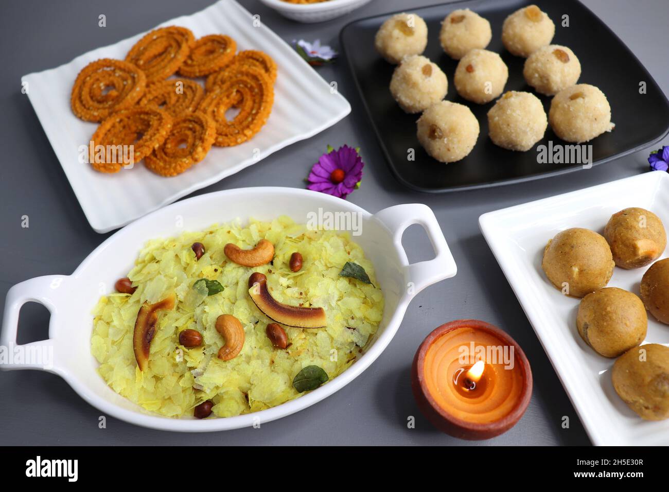 Indian festival food - Diwali Special sweet and salty snacks such as, Chakli, rava laddu, besan ladu, poha chivda, and corn mixture, Namkeen snacks. Stock Photo