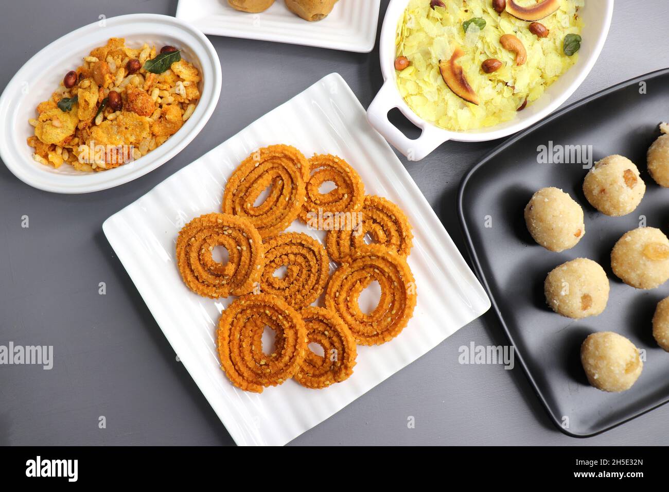 Indian festival food - Diwali Special sweet and salty snacks such as, Chakli, rava laddu, besan ladu, poha chivda, and corn mixture, Namkeen snacks. Stock Photo