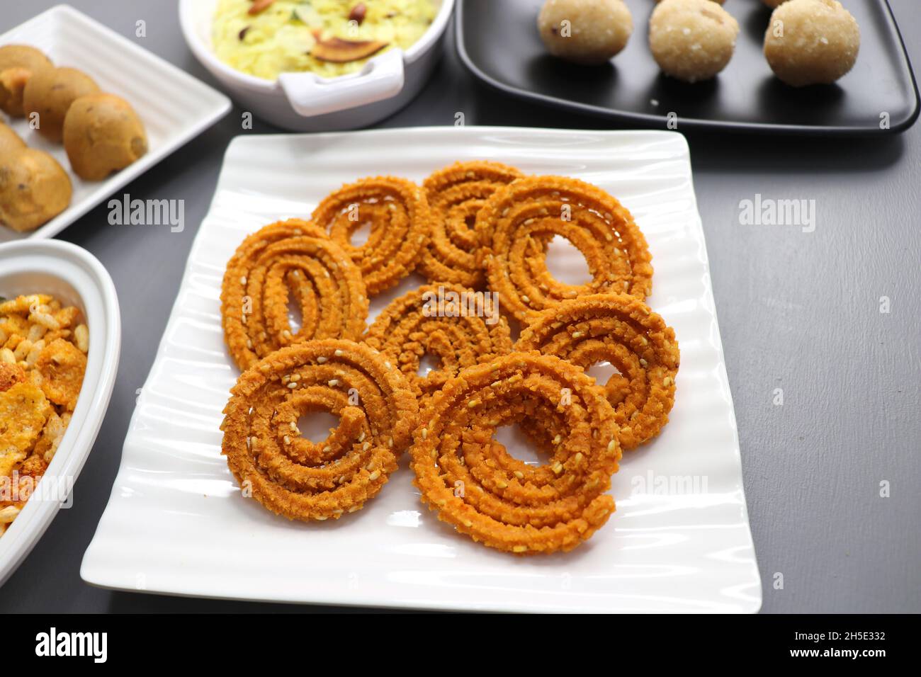 Indian festival food - Diwali Special sweet and salty snacks such as, Chakli, rava laddu, besan ladu, poha chivda, and corn mixture, Namkeen snacks. Stock Photo