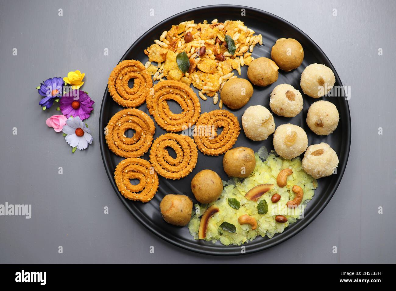 Indian festival food - Diwali Special sweet and salty snacks such as, Chakli, rava laddu, besan ladu, poha chivda, and corn mixture, Namkeen snacks. Stock Photo