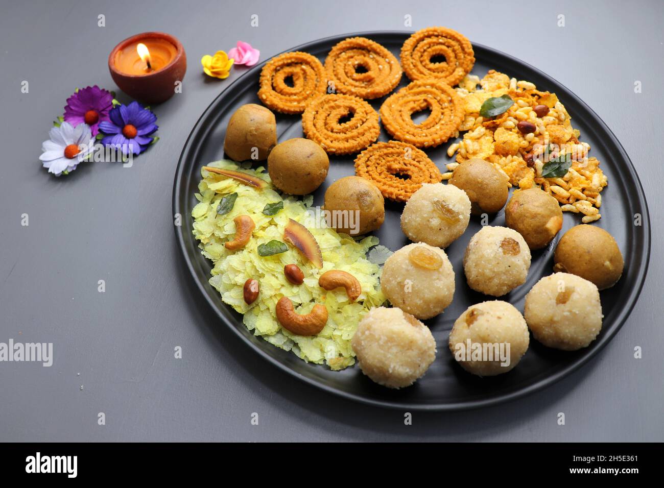 Indian festival food - Diwali Special sweet and salty snacks such as, Chakli, rava laddu, besan ladu, poha chivda, and corn mixture, Namkeen snacks. Stock Photo