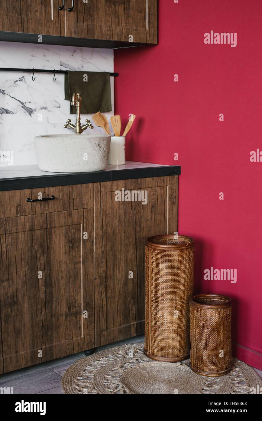 Rustic kitchen interior with vintage sink and burgundy walls Stock