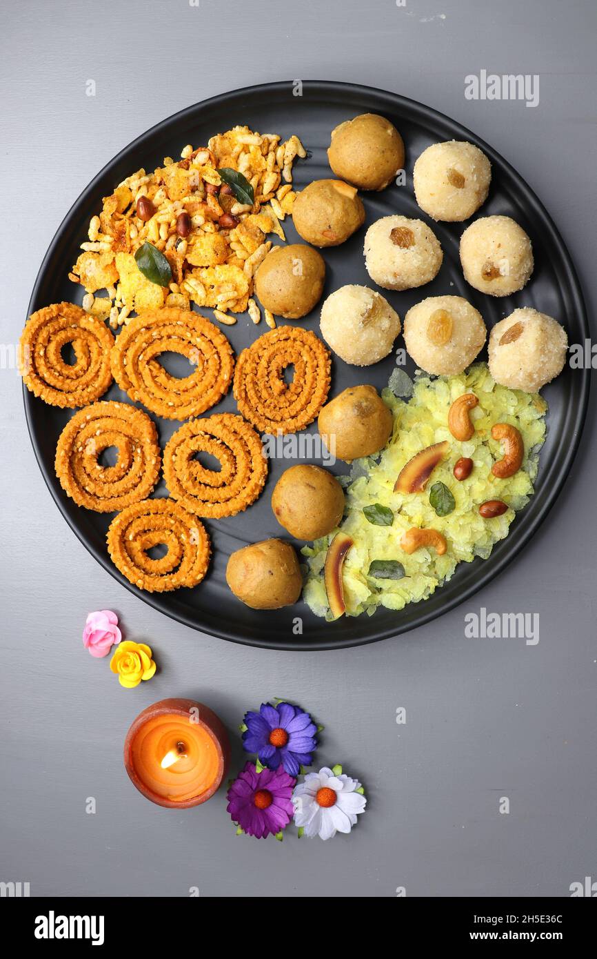 Indian festival food - Diwali Special sweet and salty snacks such as, Chakli, rava laddu, besan ladu, poha chivda, and corn mixture, Namkeen snacks. Stock Photo