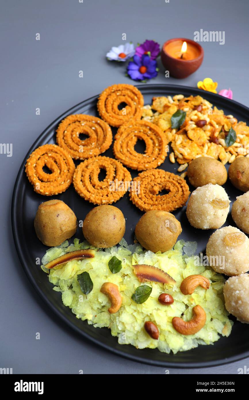 Indian festival food - Diwali Special sweet and salty snacks such as, Chakli, rava laddu, besan ladu, poha chivda, and corn mixture, Namkeen snacks. Stock Photo