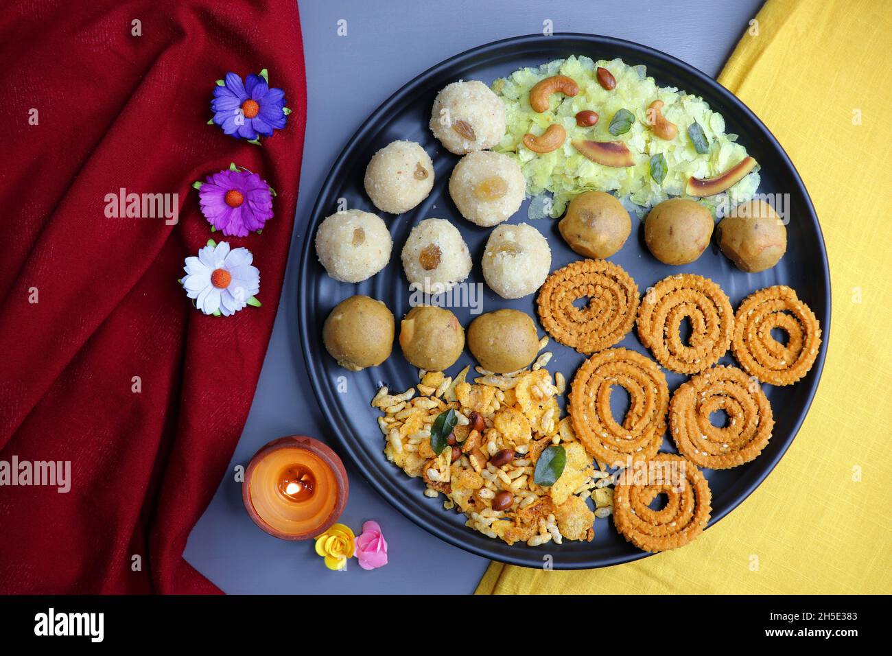 Indian festival food - Diwali Special sweet and salty snacks such as, Chakli, rava laddu, besan ladu, poha chivda, and corn mixture, Namkeen snacks. Stock Photo