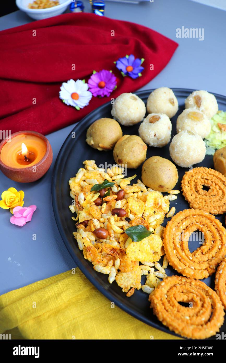 Indian festival food - Diwali Special sweet and salty snacks such as, Chakli, rava laddu, besan ladu, poha chivda, and corn mixture, Namkeen snacks. Stock Photo
