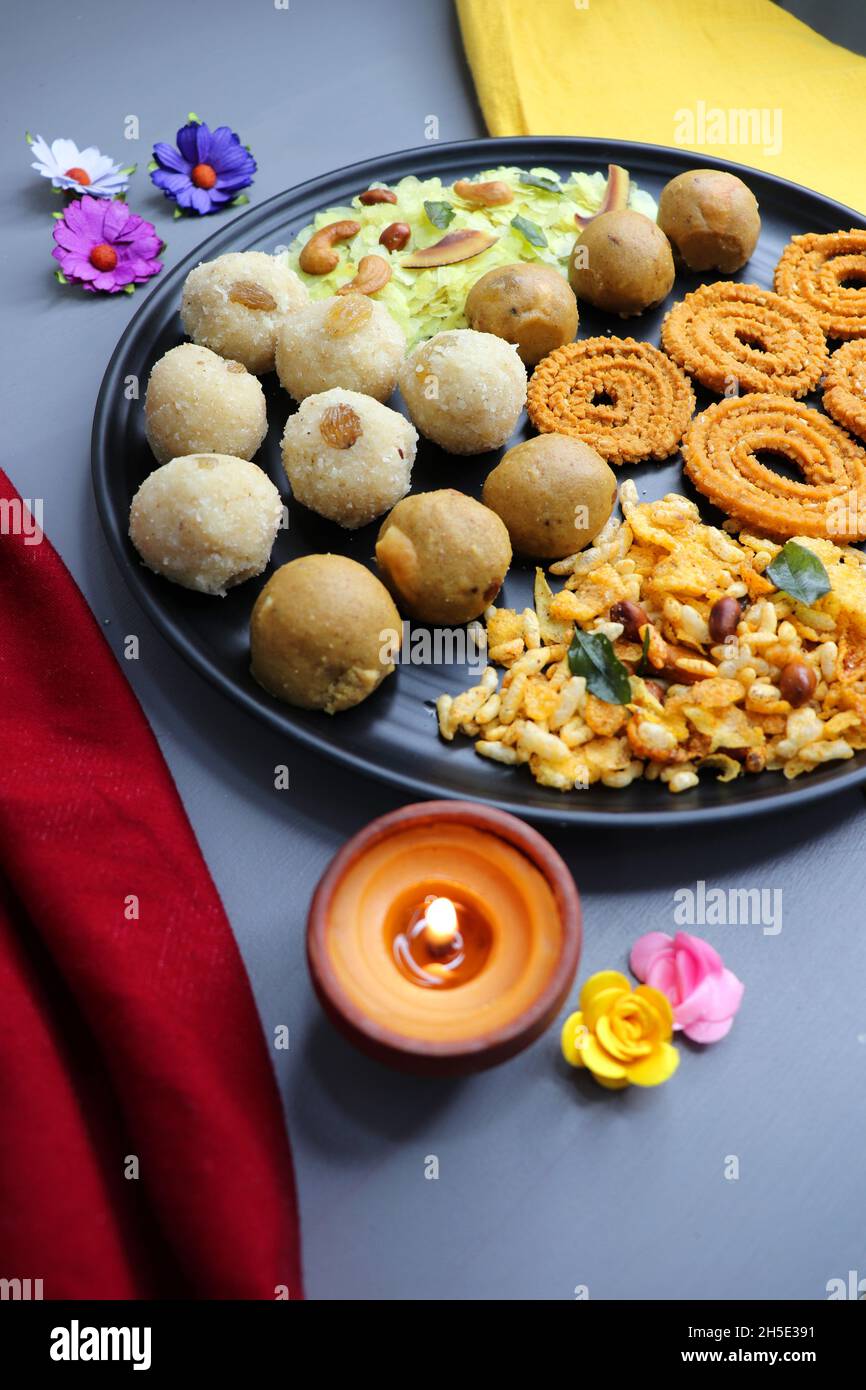 Indian festival food - Diwali Special sweet and salty snacks such as, Chakli, rava laddu, besan ladu, poha chivda, and corn mixture, Namkeen snacks. Stock Photo