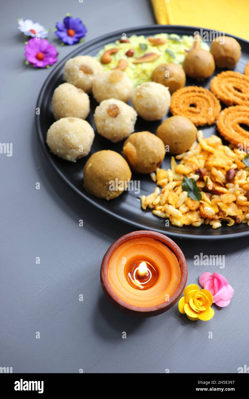 Indian festival food - Diwali Special sweet and salty snacks such as, Chakli, rava laddu, besan ladu, poha chivda, and corn mixture, Namkeen snacks. Stock Photo