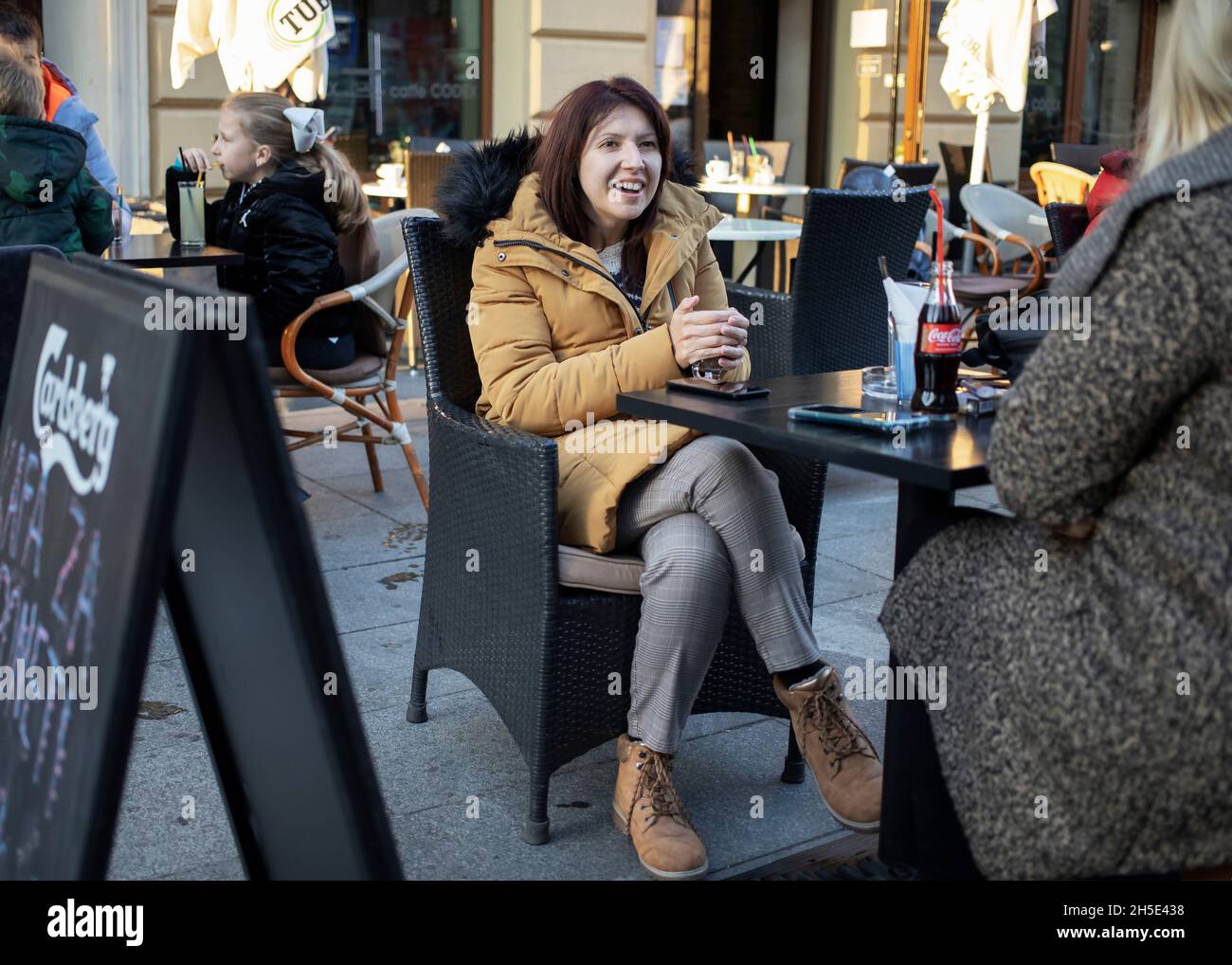 Belgrade, Serbia Oct 31, 2021: Seated woman in one of outdoor coffee shops at Gospodska Street in Zemun Stock Photo