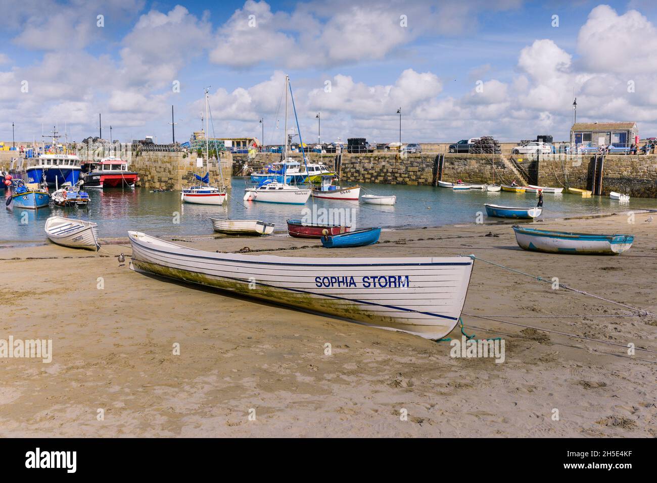 Traditional Cornish pilot gigs Sophia Storm and Concord beached on the beach in the historic picturesque working Newquay Harbour in Newquay in Cornwal Stock Photo