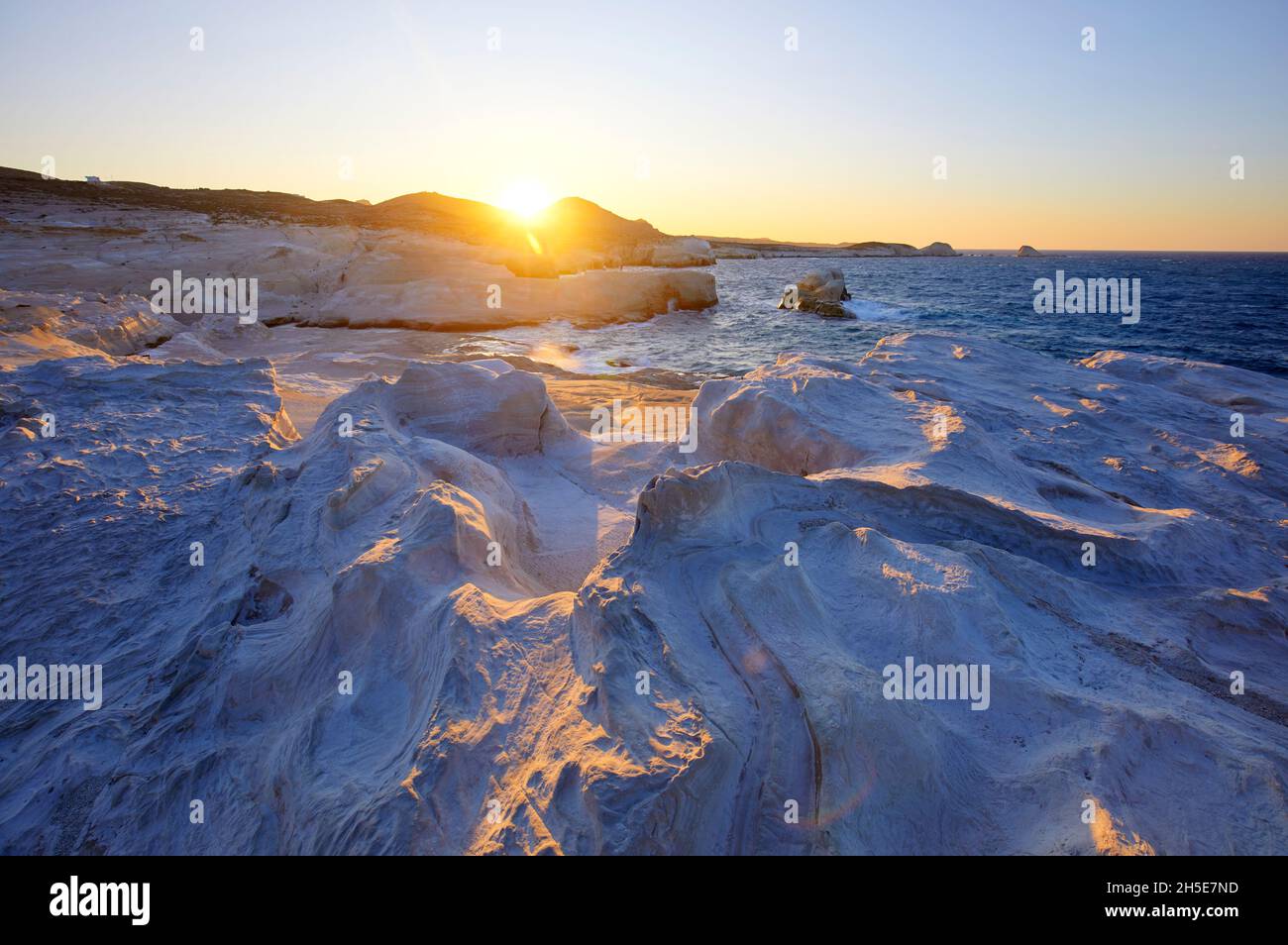 The White Cliffs Of Sarakiniko Beach At Sunset Milos Greece Stock the-white-cliffs-of-sarakiniko-beach-at-sunset-milos-greece-stock