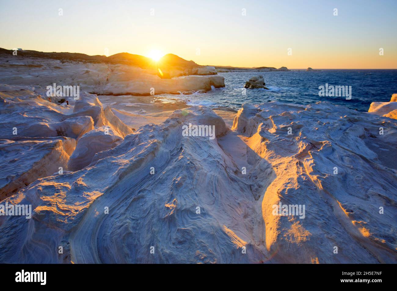 The White Cliffs Of Sarakiniko Beach At Sunset Milos Greece Stock the-white-cliffs-of-sarakiniko-beach-at-sunset-milos-greece-stock