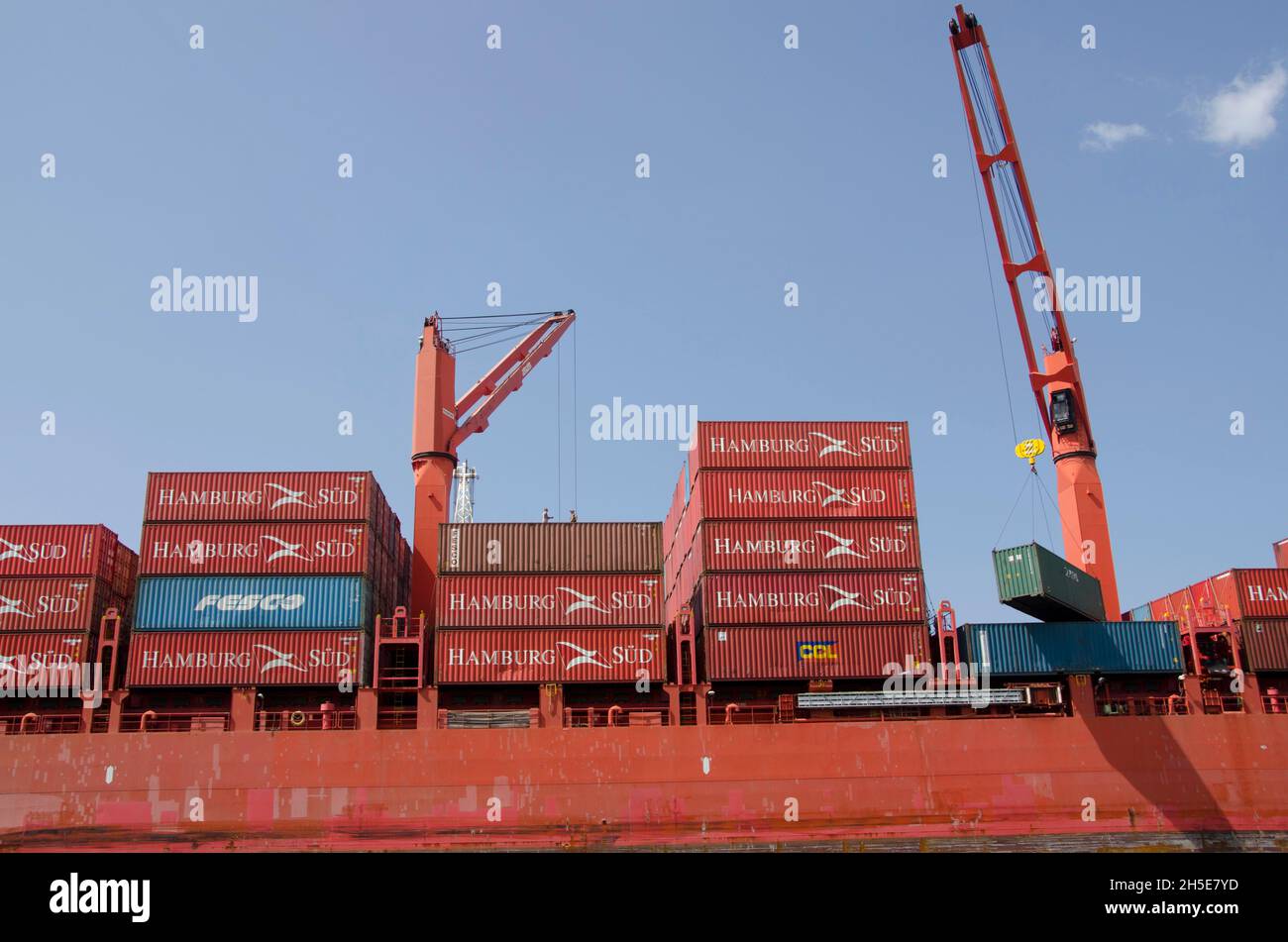 Cargo Container ship moored at a dock in the port waiting to be downloaded. Stock Photo