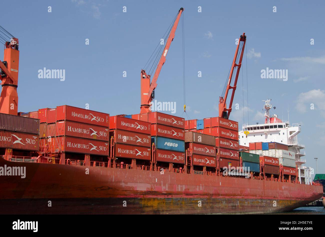 Moored container ship waiting for clearance to leave the harbor to return to it's original destination with already emptied containers Stock Photo