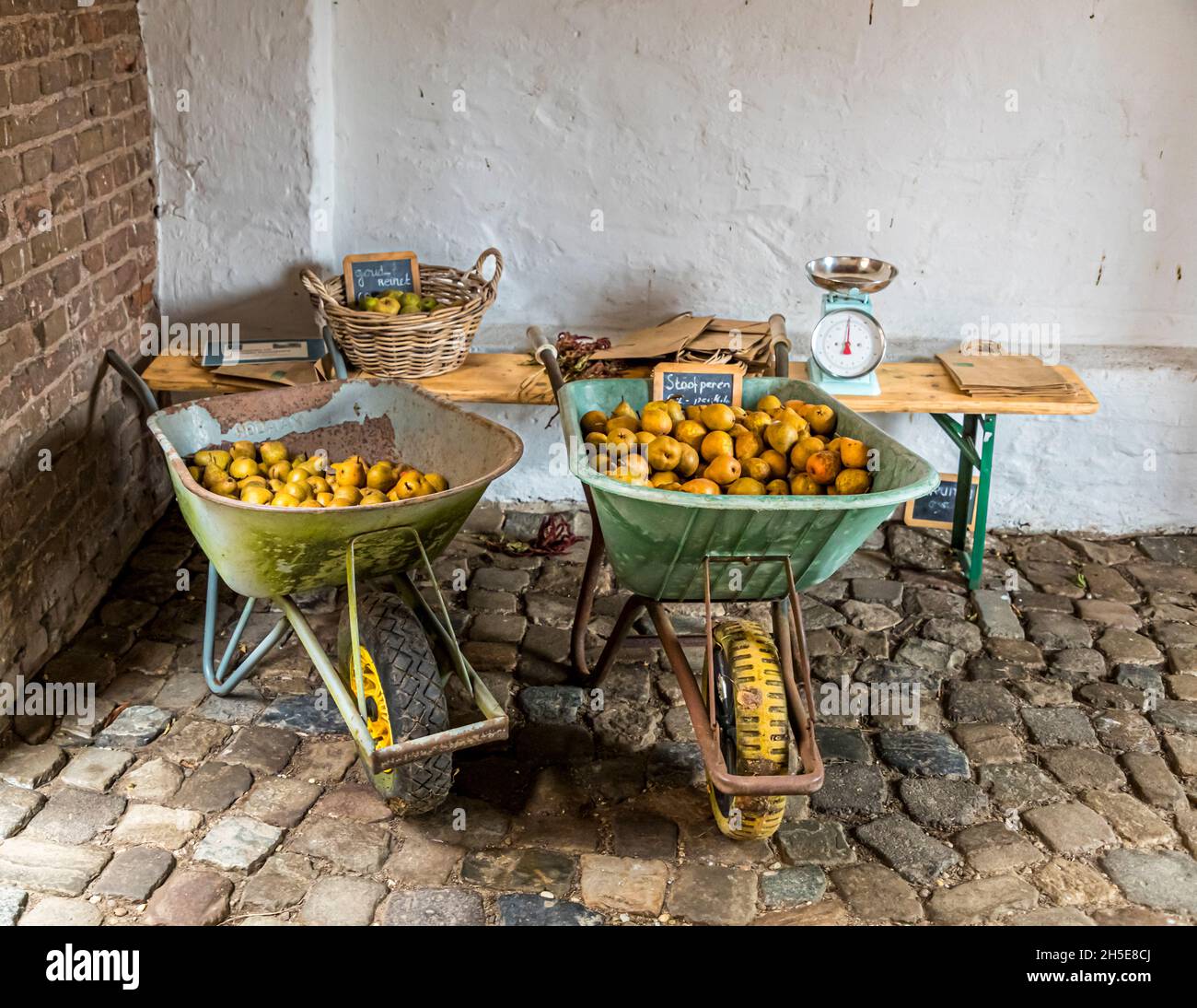 Doorwerth Castle houses three museums. Doorwerth, Netherlands. Pears from own production are offered for sale in wheelbarrows Stock Photo