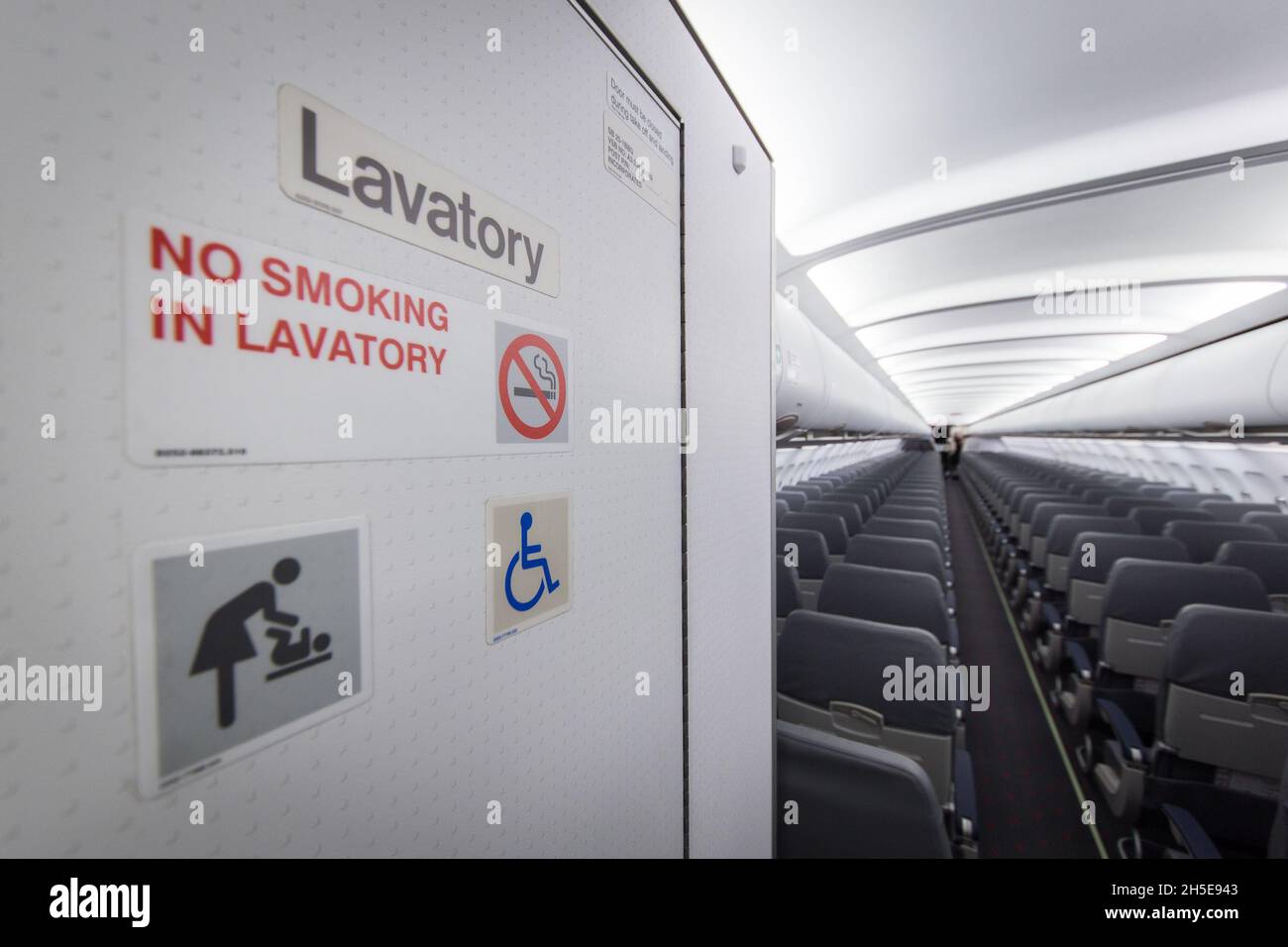 Door of lavatory in an empty aircraft cabin Stock Photo Alamy