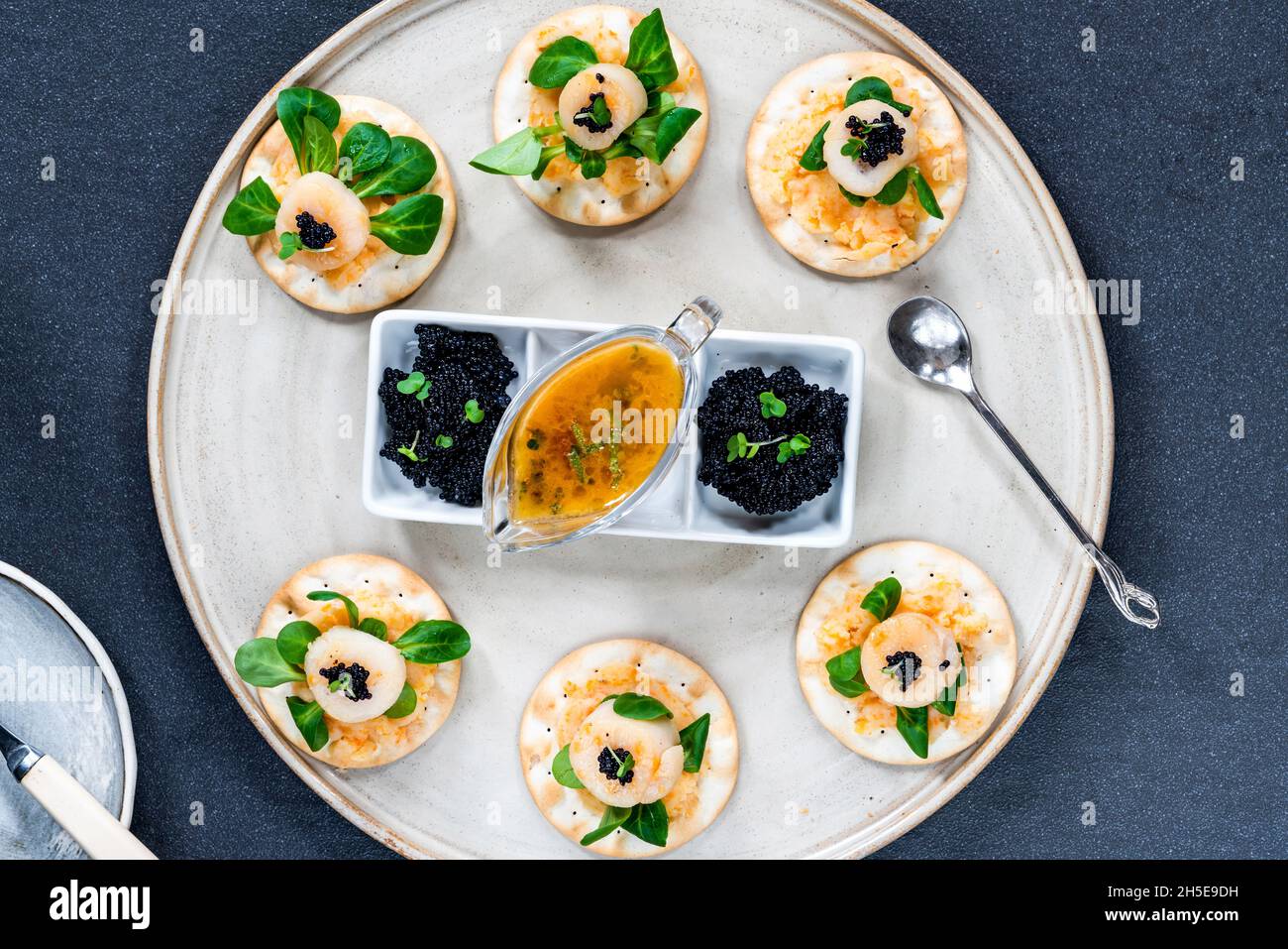 Canapes with scallops, caviar and lime and butter sauce overhead view