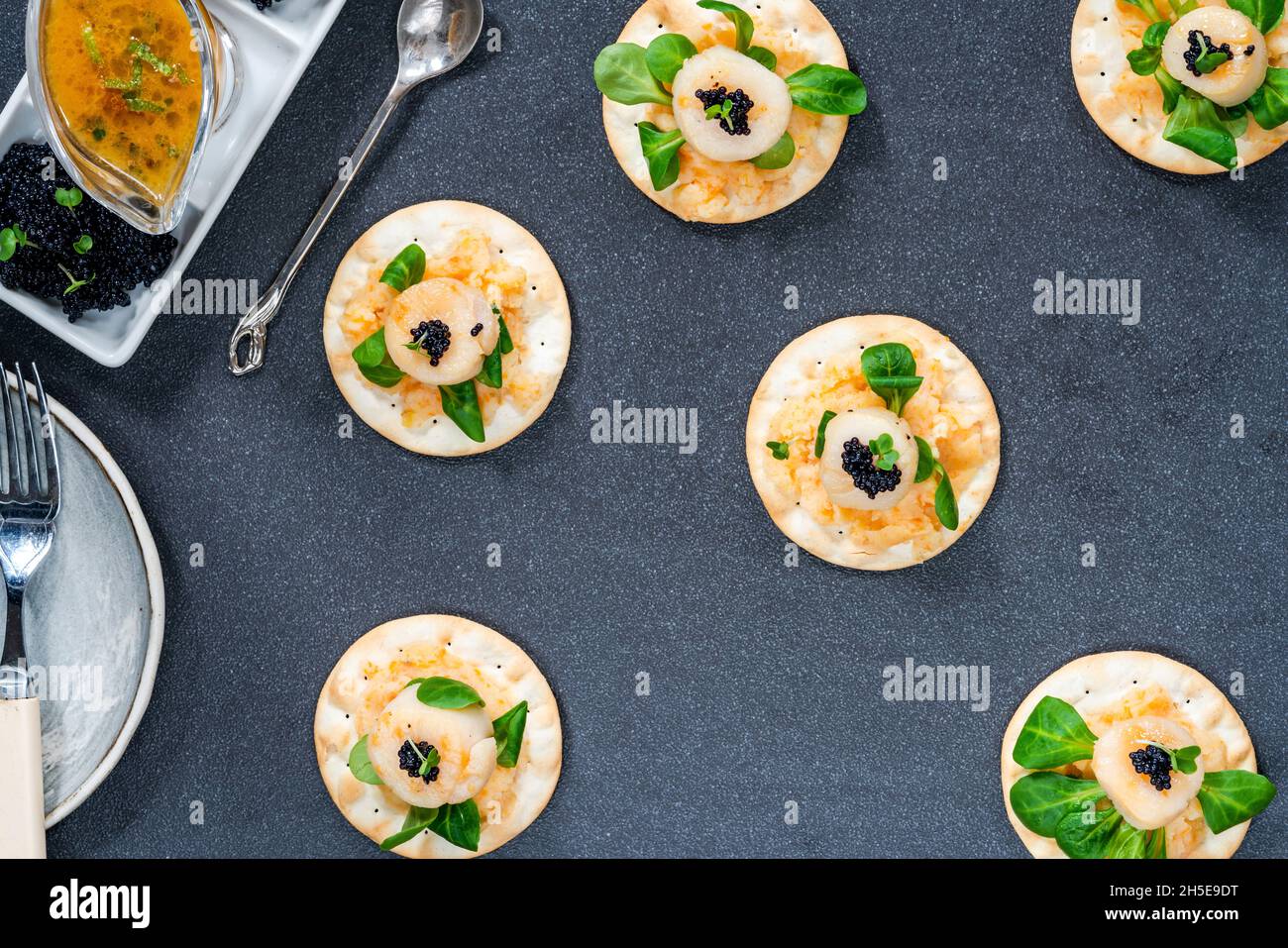 Canapes with scallops, caviar and lime and butter sauce - overhead view Stock Photo