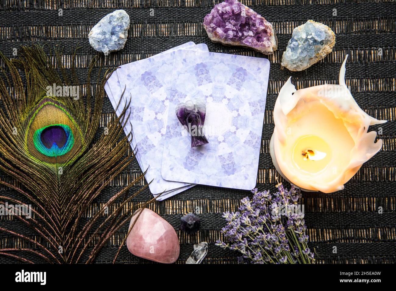 Deck with divination homemade Angel cards on black table, surrounded with semi precious stones crystals. Stock Photo
