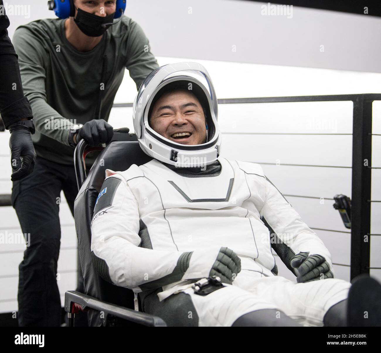 Japan Aerospace Exploration Agency (JAXA) astronaut Aki Hoshide reacts to a comment after being helped out of the SpaceX Crew Dragon Endeavour spacecraft onboard the SpaceX GO Navigator recovery ship after he and NASA astronauts Shane Kimbrough and Megan McArthur, and ESA (European Space Agency) astronaut Thomas Pesquet landed in the Gulf of Mexico off the coast of Pensacola, Florida, Monday, Nov. 8, 2021. NASA’s SpaceX Crew-2 mission is the second operational mission of the SpaceX Crew Dragon spacecraft and Falcon 9 rocket to the International Space Station as part of the agency’s Commercial Stock Photo