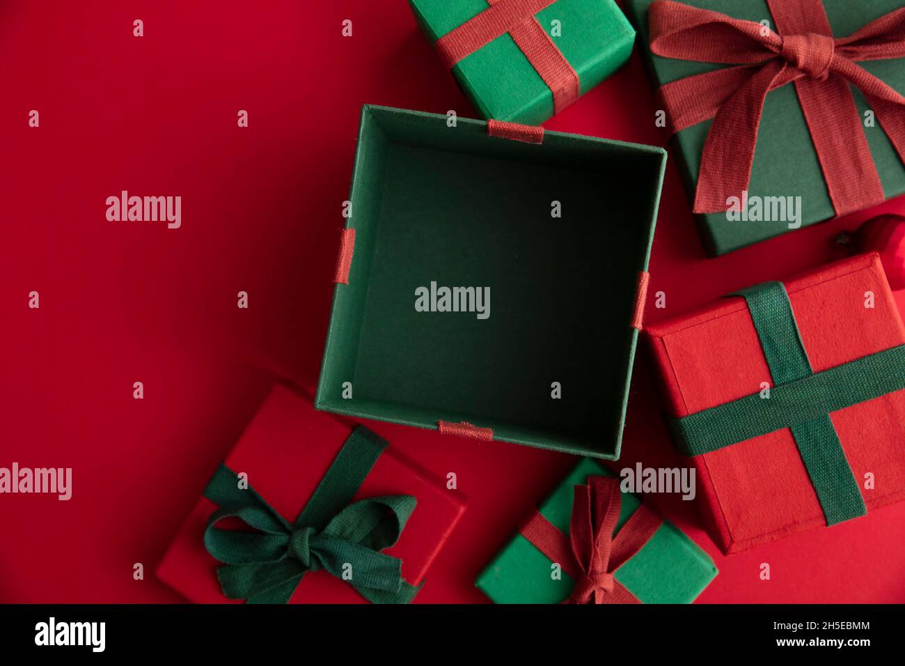 Open festive christmas present box on a red background. Flat lay, top view Stock Photo