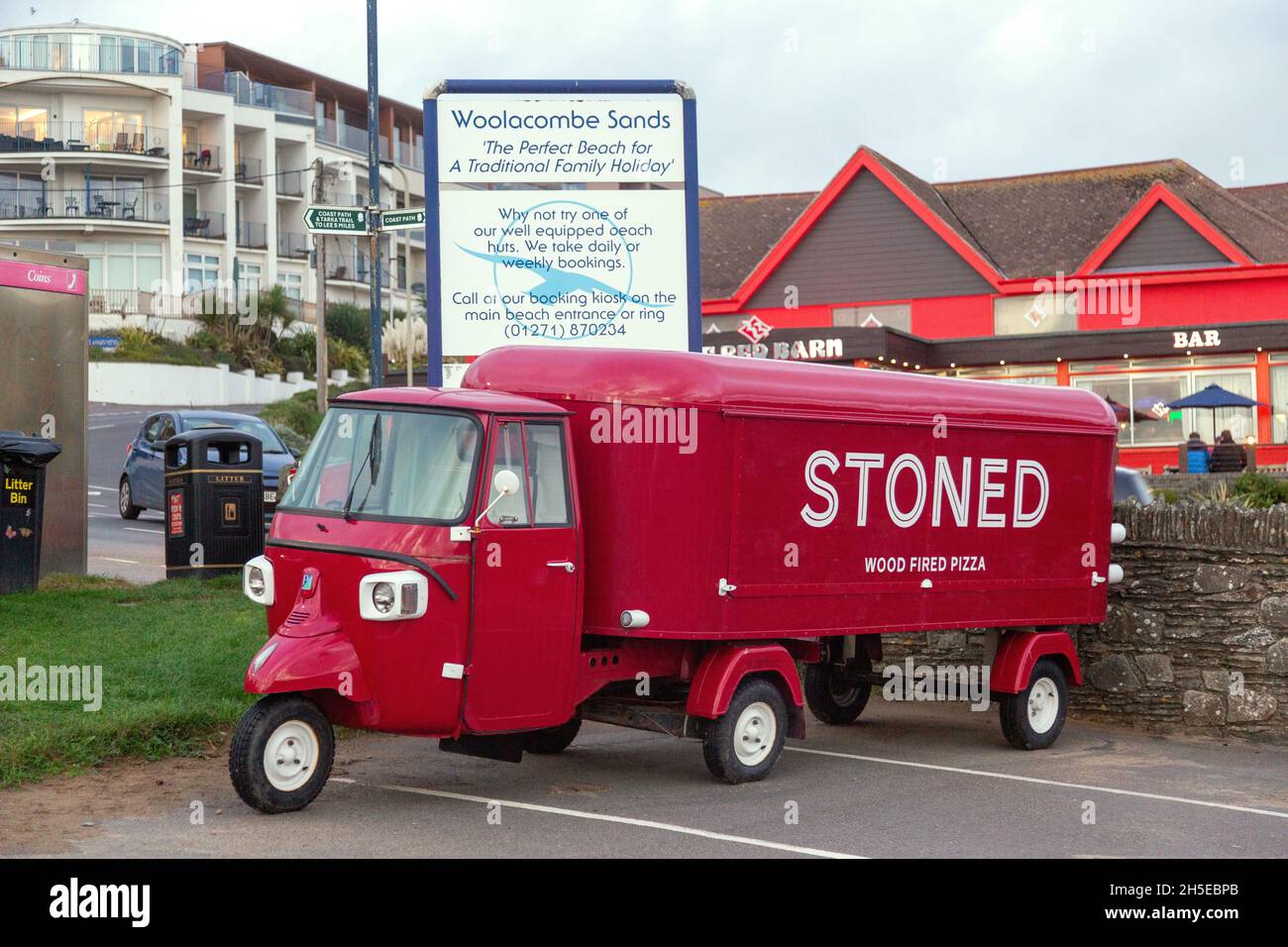 Piaggio TM three wheeled scooter truck converted to a wood fired pizza takeaway truck. Woolacombe, Devon , England, United Kingdom. Stock Photo