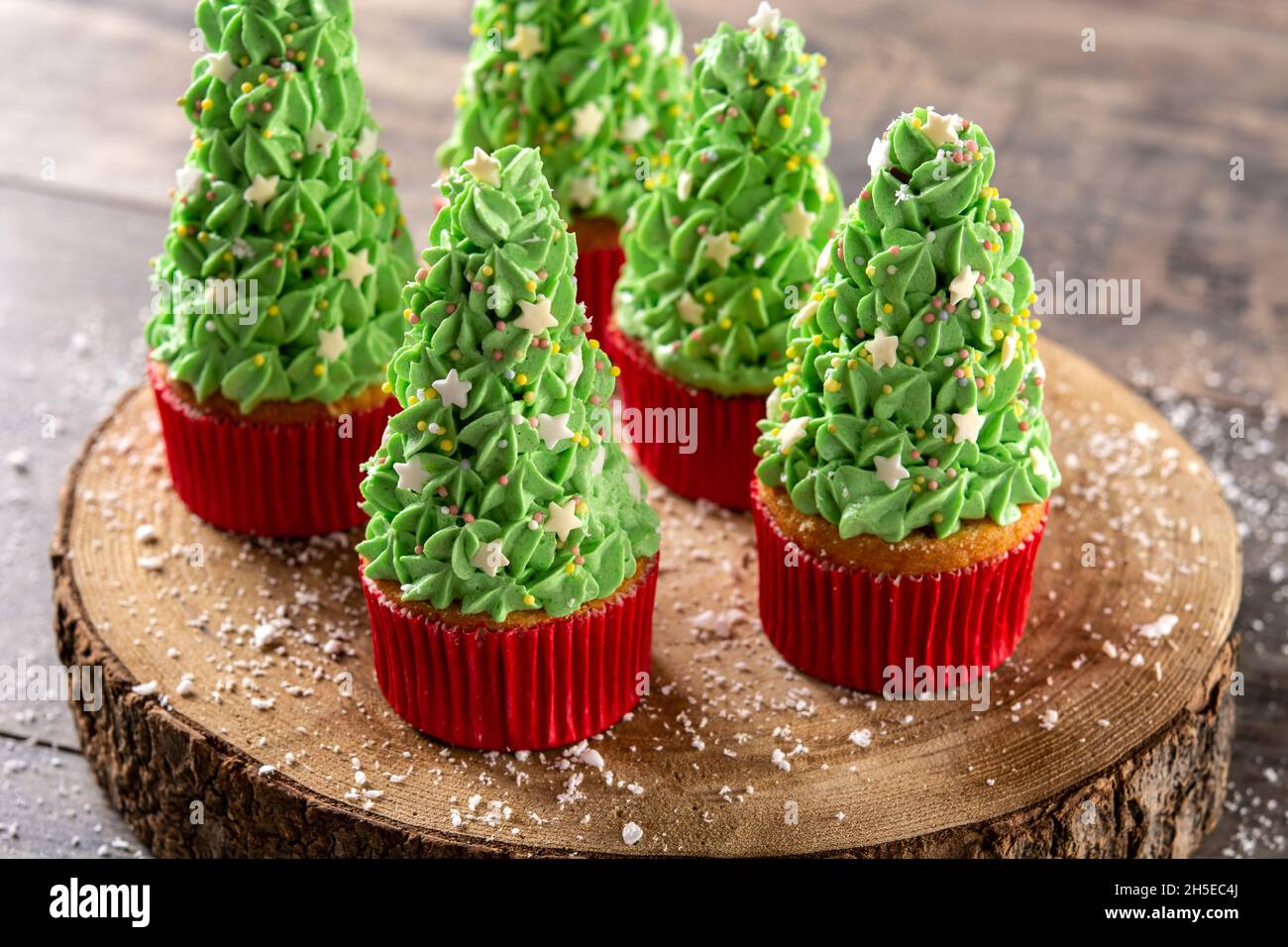 Christmas tree cupcakes on wooden table Stock Photo