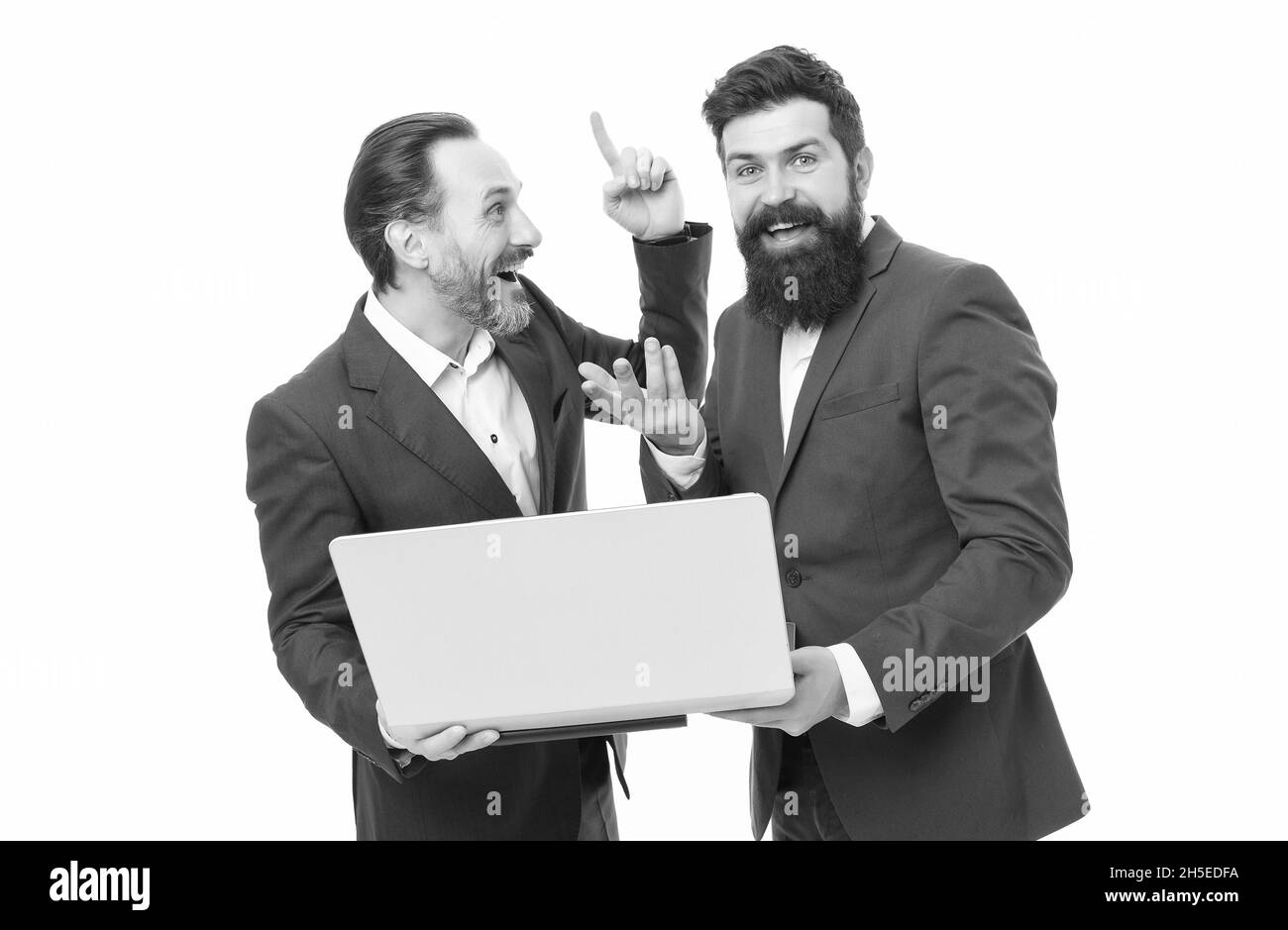 Big idea for great result. Bearded men got business idea. Happy businessmen use computer. Pointing index finger up. E-business. Investing in high-tech Stock Photo