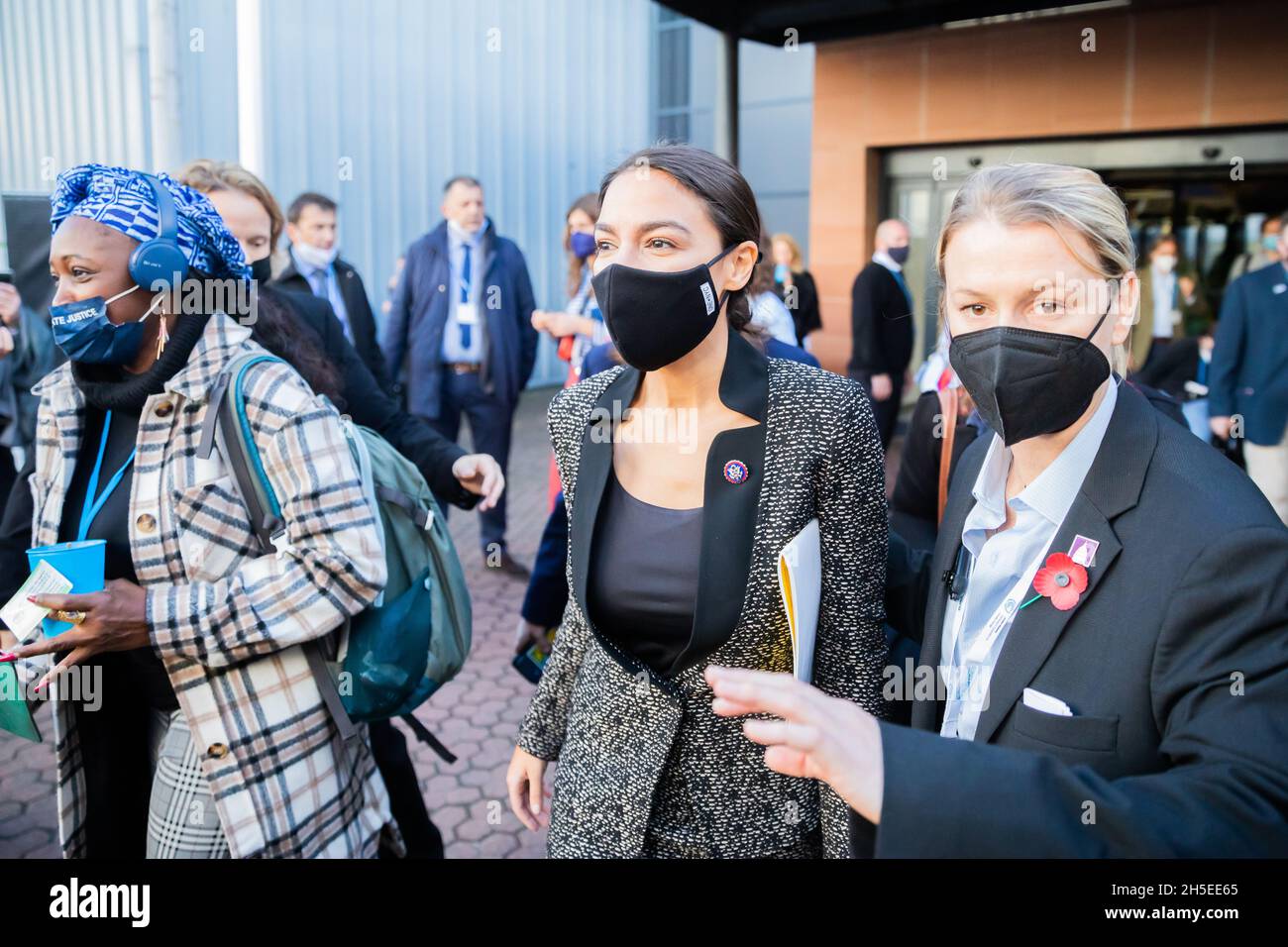 Glasgow, UK. 09th Nov, 2021. Alexandria Ocasio-Cortez (M), Democratic US Congresswoman and Representative for New York State, arrives at the UN Climate Change Conference COP26 in Glasgow. For two weeks in Glasgow, some 200 countries are wrestling with how to still achieve the goal of limiting global warming to 1.5 degrees compared to pre-industrial times, if possible. Credit: Christoph Soeder/dpa/Alamy Live News Stock Photo