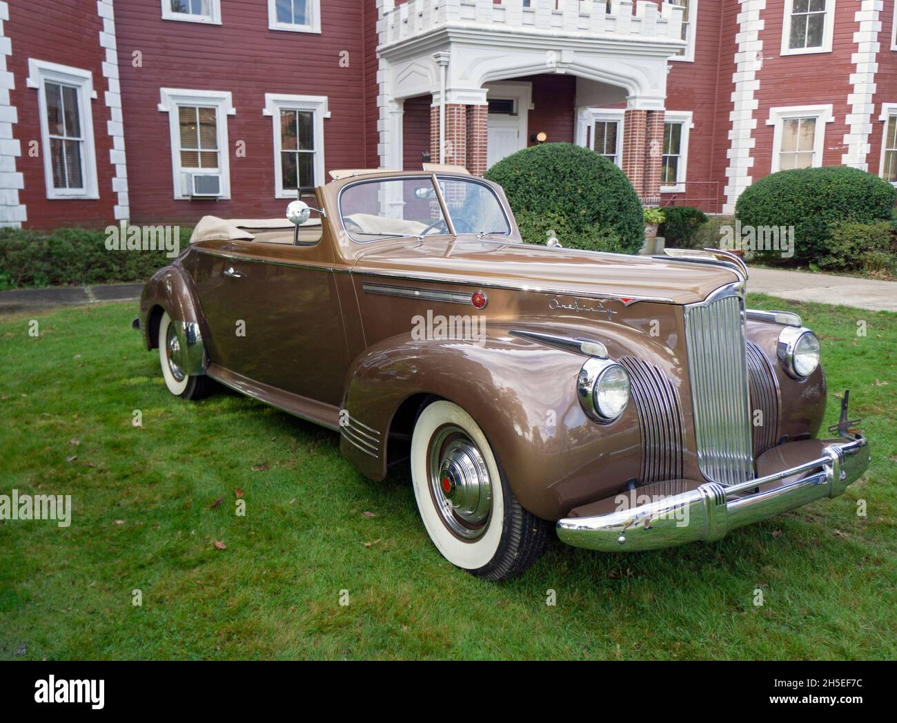 An antique 1941 Packard 160 convertible parked outside the Bayside Historical Society in Queens at a vintage car show. Stock Photo