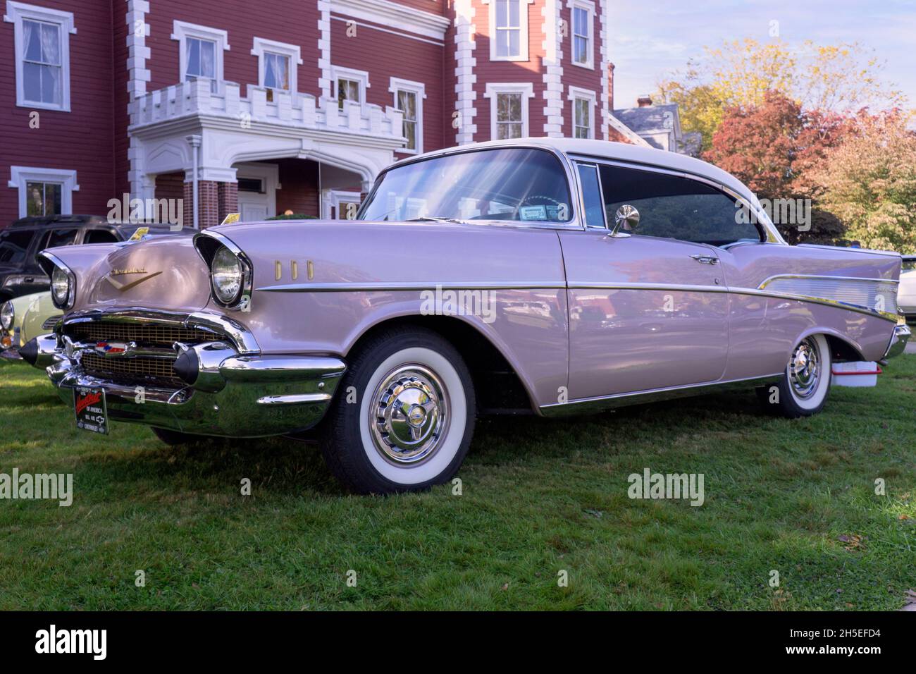 An antique 1957 Chevrolet Bel Air two door sedan parked outside the Bayside Historical Society in Queens at a vintage car show. Stock Photo
