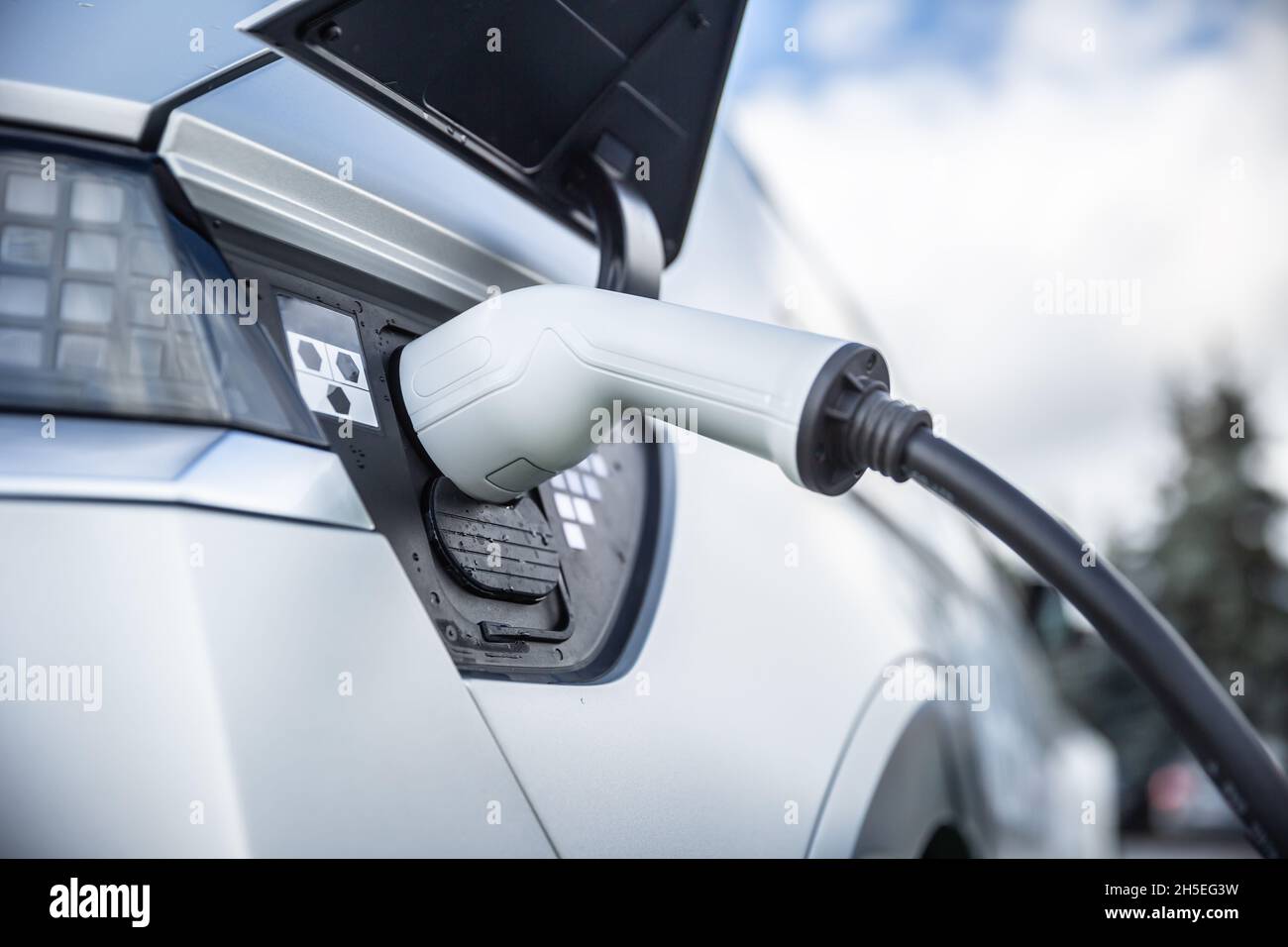 Charging connector connected to the electrical socket of a hybrid car ...