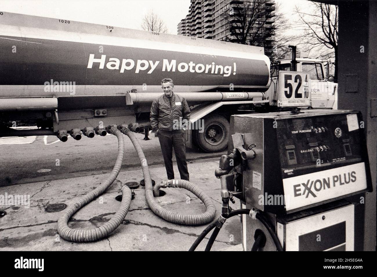 HAPPY MOTORING. An Exxon truck and driver refill the pumps at gas station in Brooklyn, circa 1975.NYC, USA, Brooklyn, New York, America, United States Stock Photo