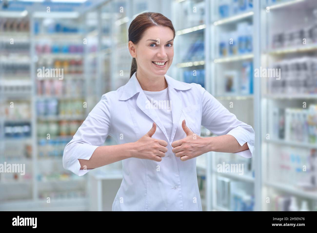 Cheerful young woman pharmacist in hi-res stock photography and images ...