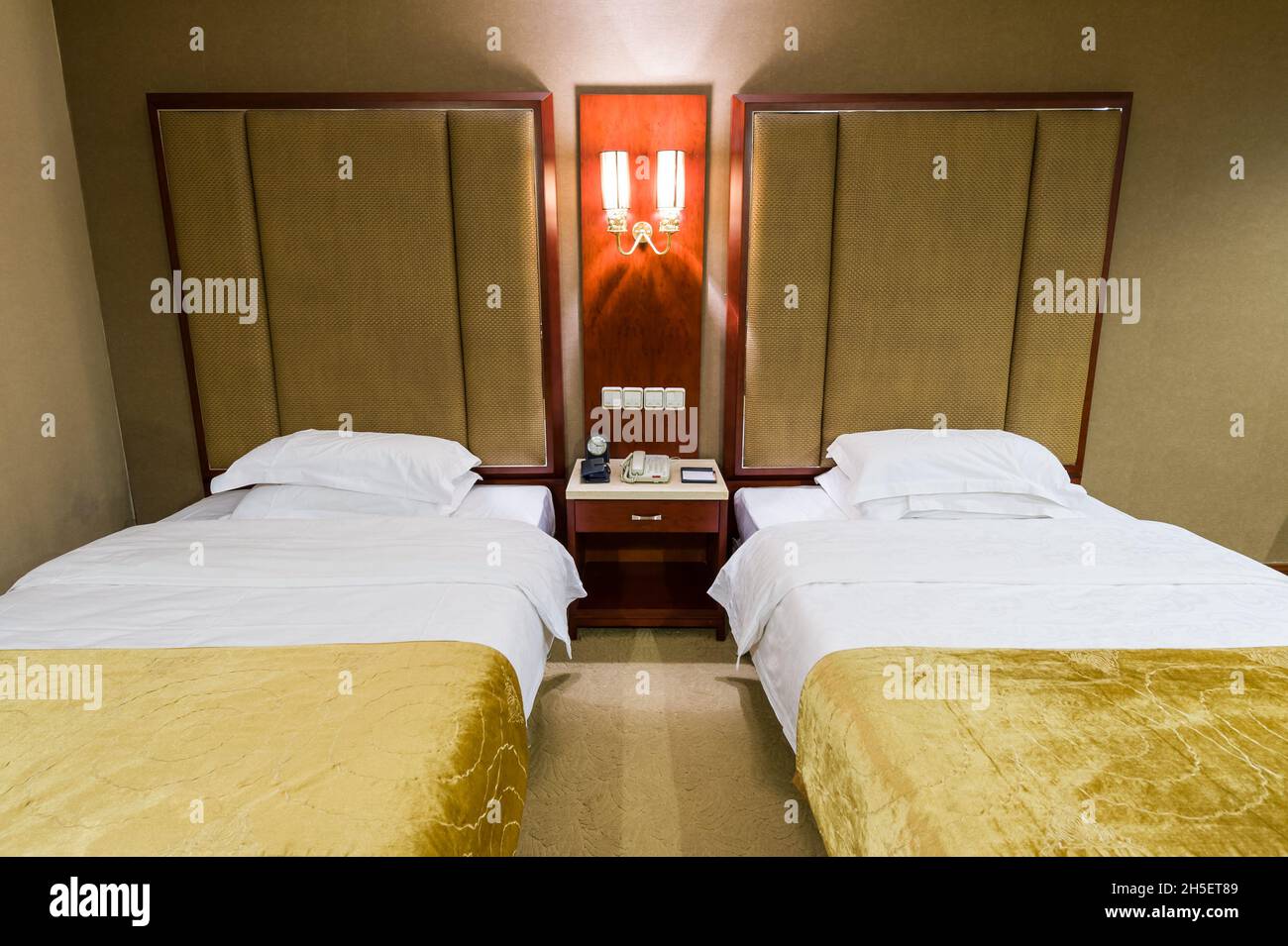 Luxurious interior of spacious hotel room with twin beds. Stock Photo