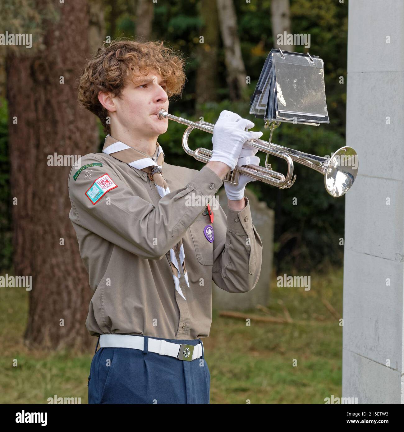 Sunday 7th November 2021. Trumpeter of the Scout Band sounds the last post and later reveille. Brookwood Last Post Association hold their monthly service with hundreds of scouts, guides & the 1st Claygate Scout & Guide Band. Air Forces Shelter, Brookwood Military Cemetery, Surrey. Stock Photo