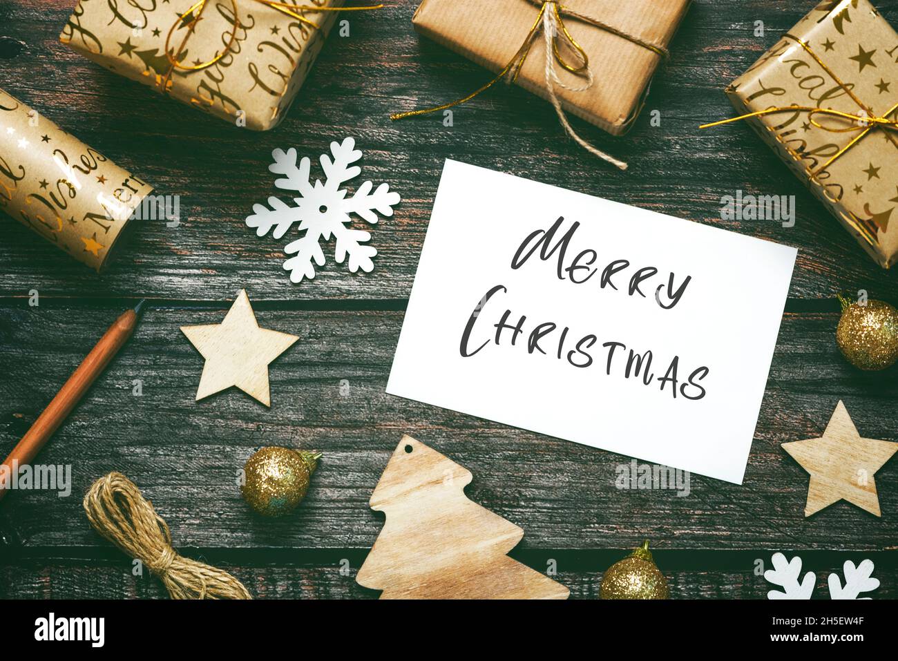 Merry Christmas. Top view of Christmas ornaments and christmas greeting card on wooden table. Christmas concept background Stock Photo