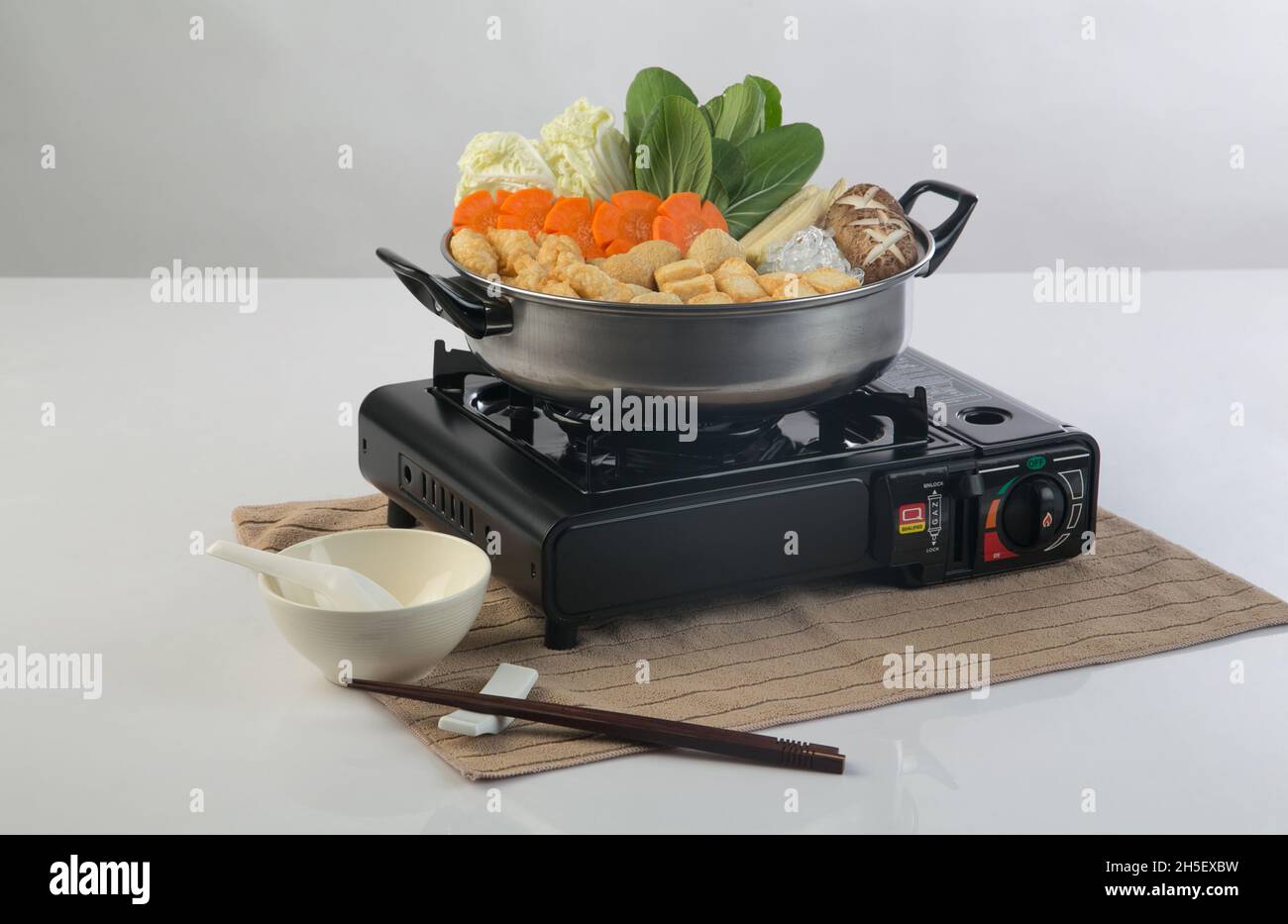 Black portable tourist gas stove with sukiyaki pot isolated on white background Stock Photo