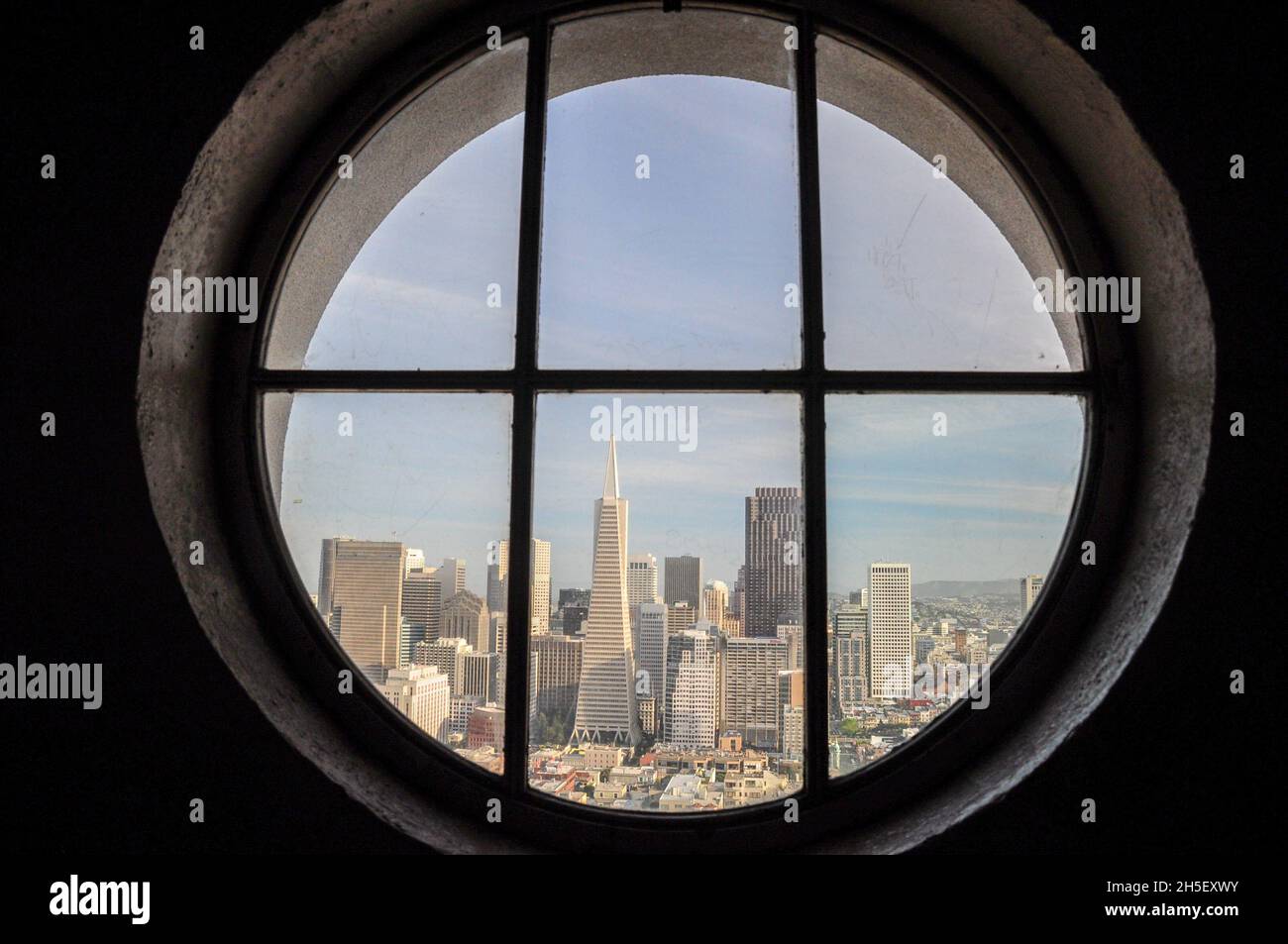 View of the buildings of San Francisco's Downtown seen from one of the windows of the Coit Tower Stock Photo