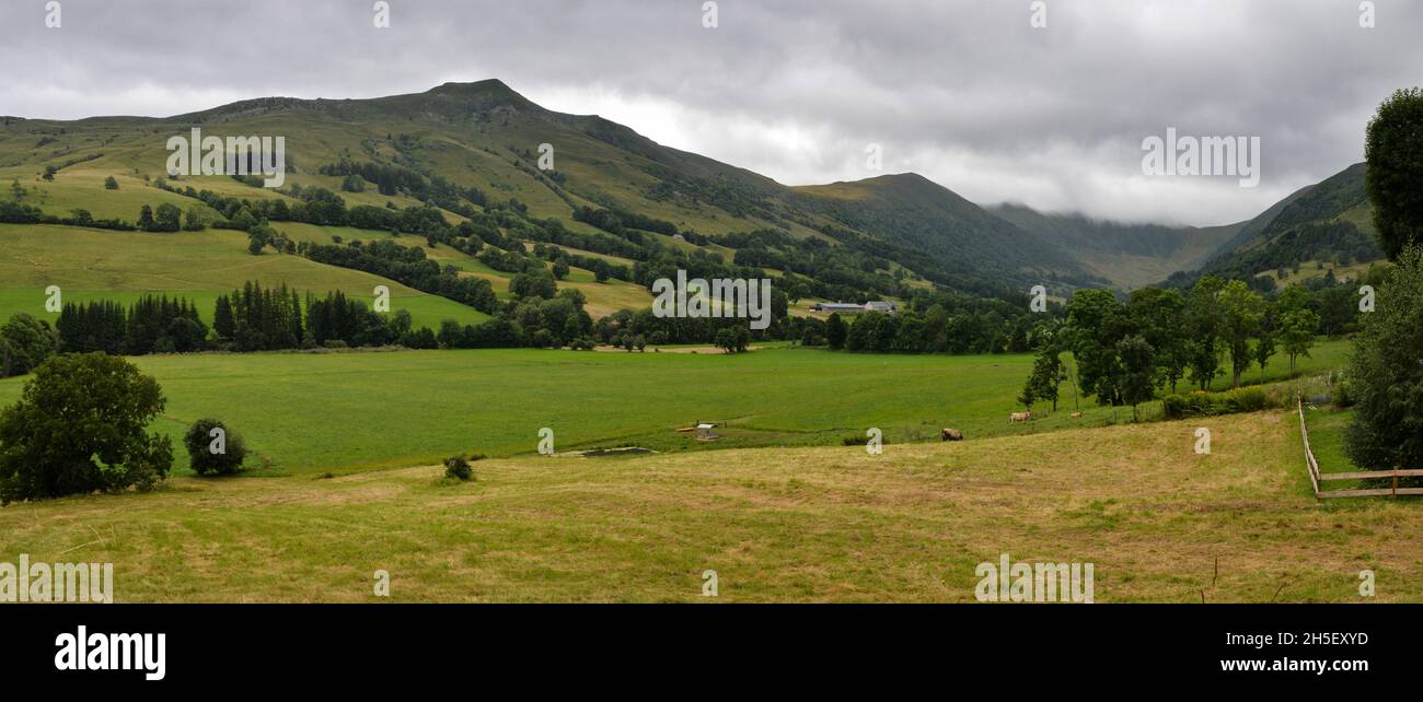Beautiful landscape with a valley with volcanic mountains range under an overcast sky. Stock Photo