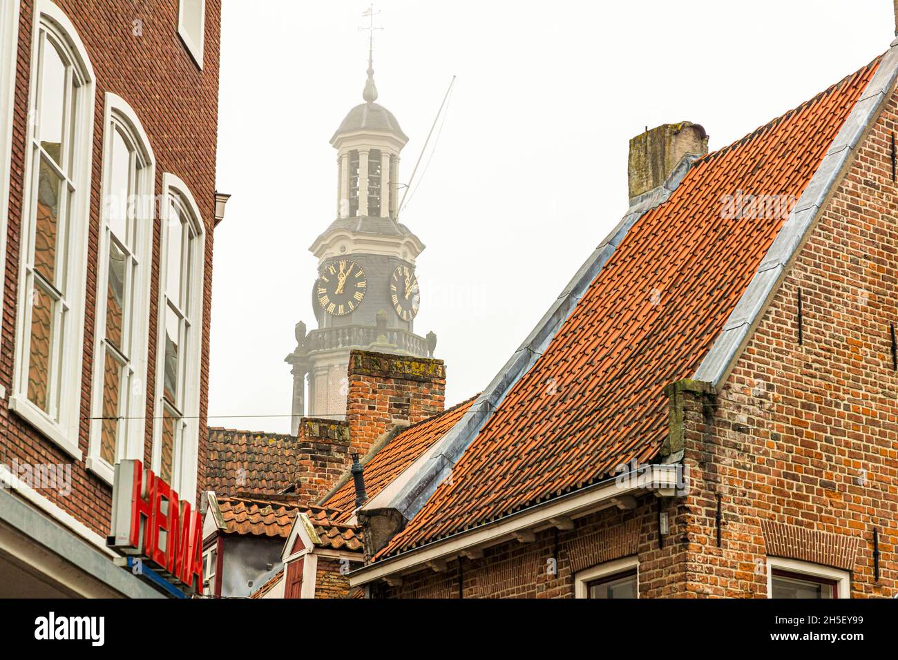 Tower clock of the Wijnhuistoren above the roofs of Zutphen, Netherlands Stock Photo