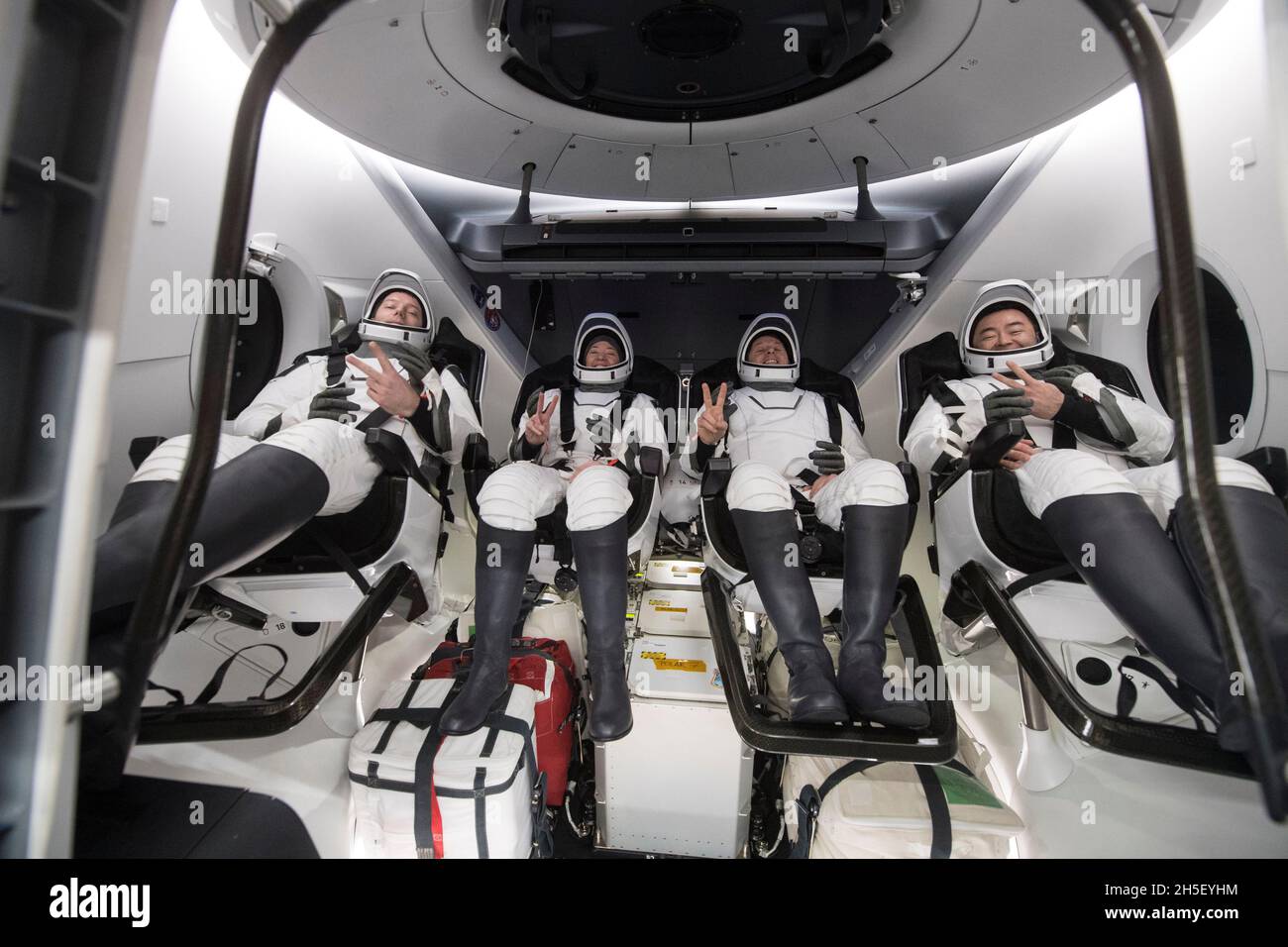 ESA (European Space Agency) astronaut Thomas Pesquet, left, NASA astronauts Megan McArthur and Shane Kimbrough, and Japan Aerospace Exploration Agency (JAXA) astronaut Aki Hoshide, right, are seen inside the SpaceX Crew Dragon Endeavour spacecraft onboard the SpaceX GO Navigator recovery ship shortly after having landed in the Gulf of Mexico off the coast of Pensacola, Florida, Monday, Nov. 8, 2021. NASA's SpaceX Crew-2 mission is the second operational mission of the SpaceX Crew Dragon spacecraft and Falcon 9 rocket to the International Space Station as part of the agency's Commercial Crew Pr Stock Photo