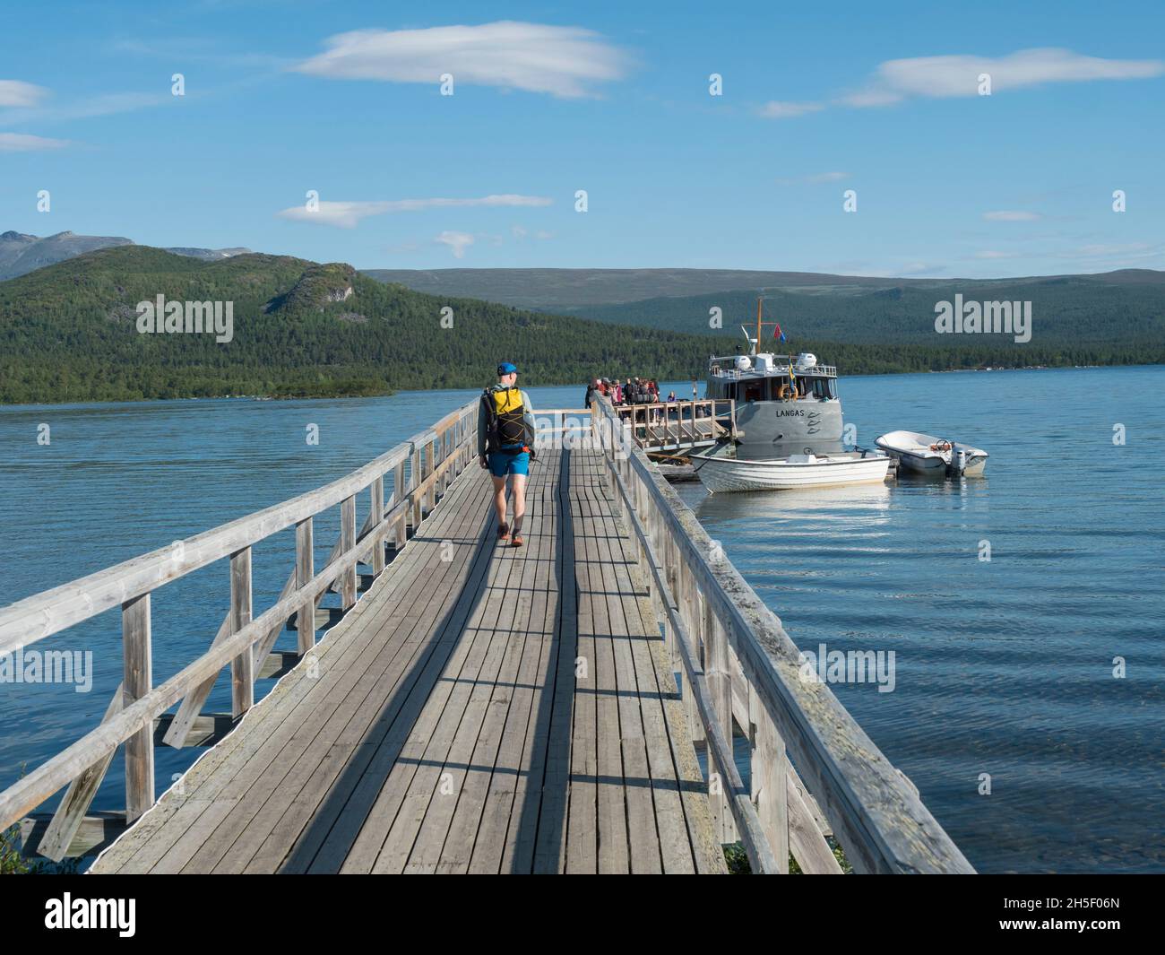 Saltoluokta, Norrbotten, Sweden, Agust 7, 2021: group of hikers and tourist getting in ferry boat ship transport from Saltoluokta to Vakkotavare to Stock Photo