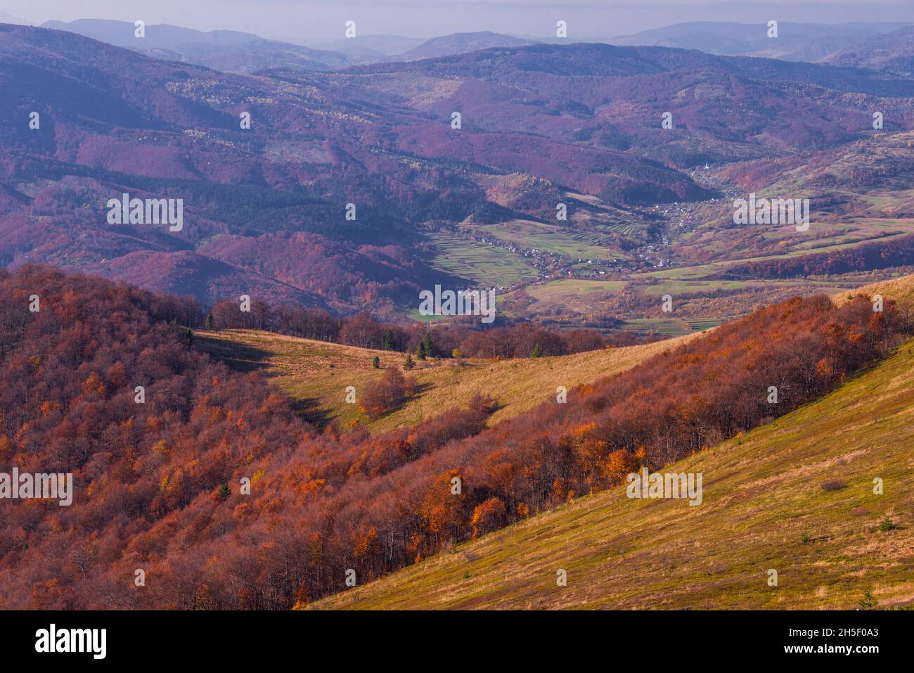 View of hills of Water Dividing ridge covered in red, orange and yellow ...