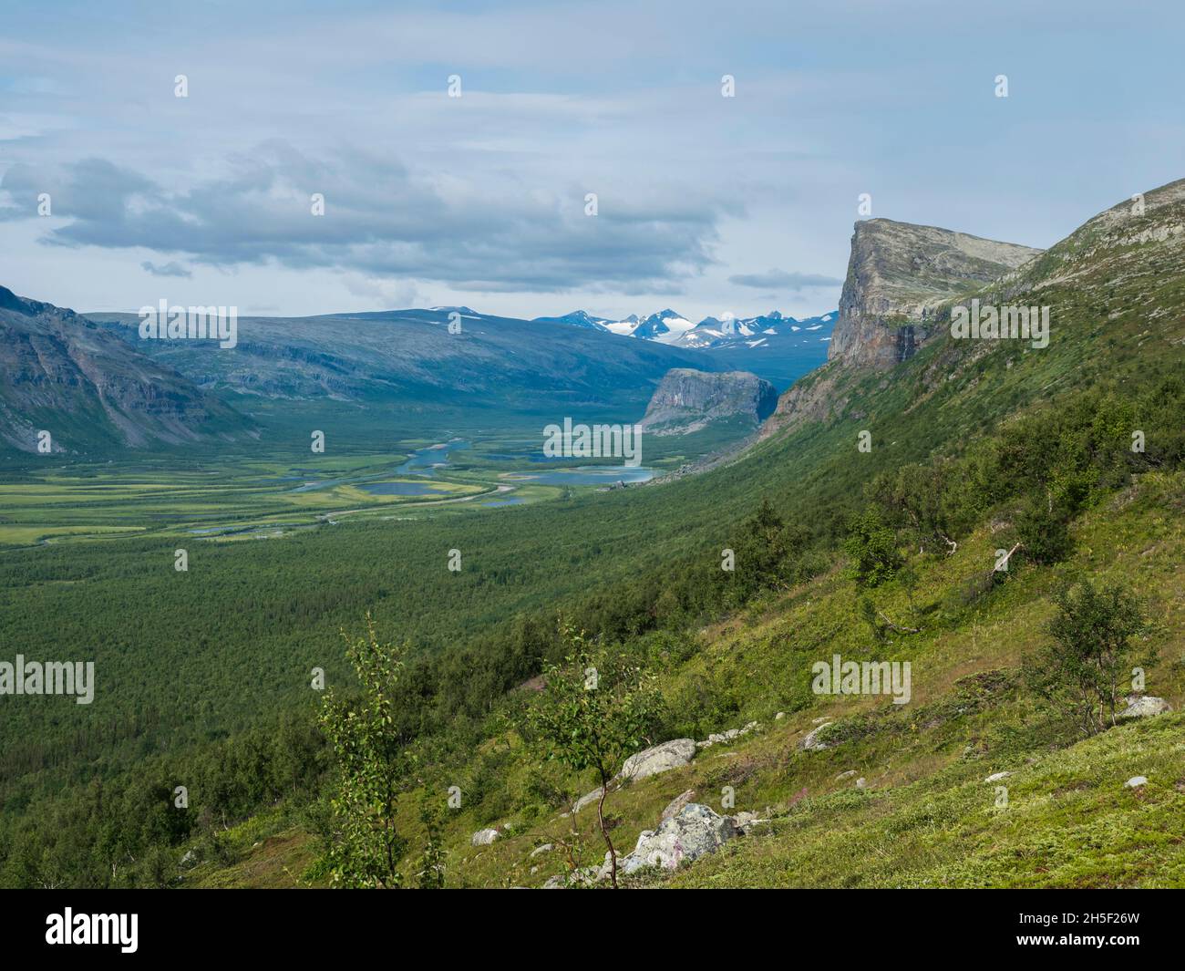 View on meandering glacial Rapadalen river delta valley at Sarek national park, Sweden Lapland with Skierffe rock peak, snow capped mountains and Stock Photo