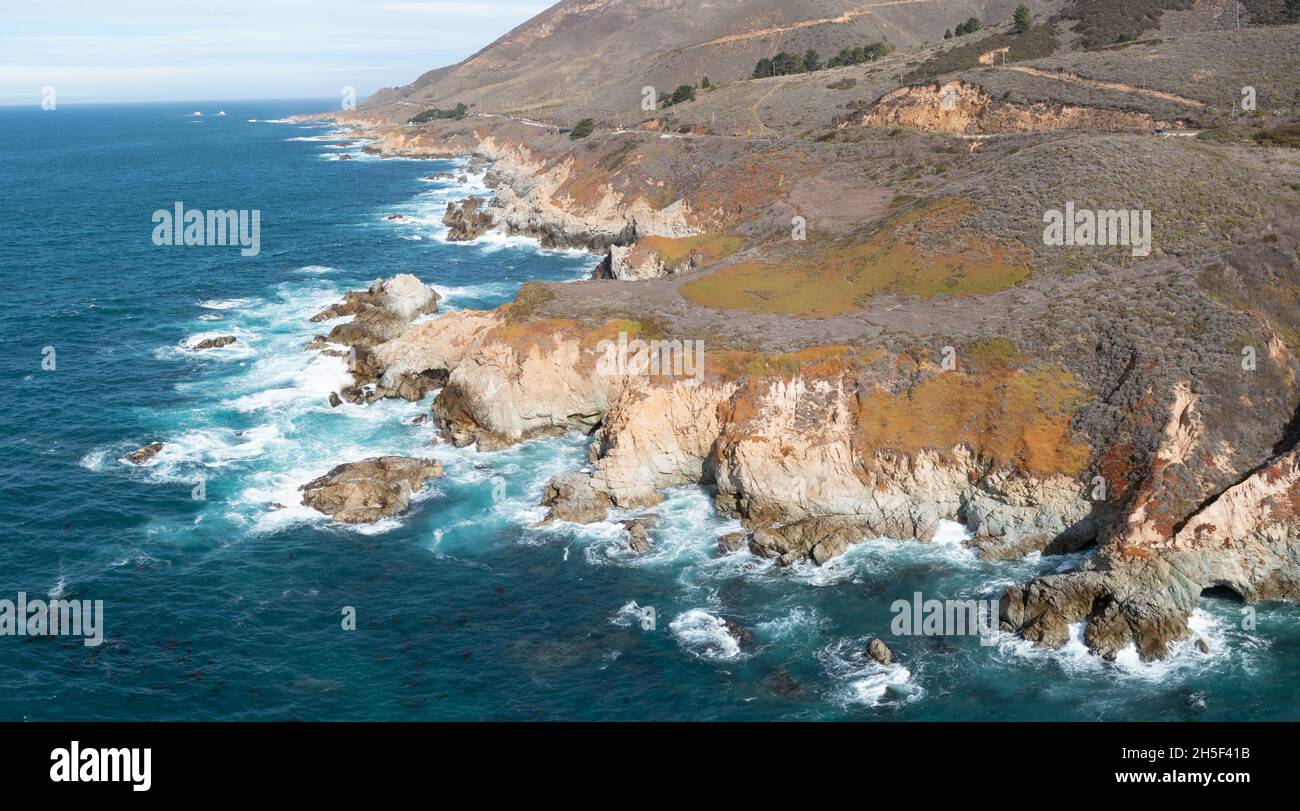 The Pacific Ocean washes onto the beautiful seashore of California, not far south of Monterey. The Pacific Coast Highway runs right along this region. Stock Photo