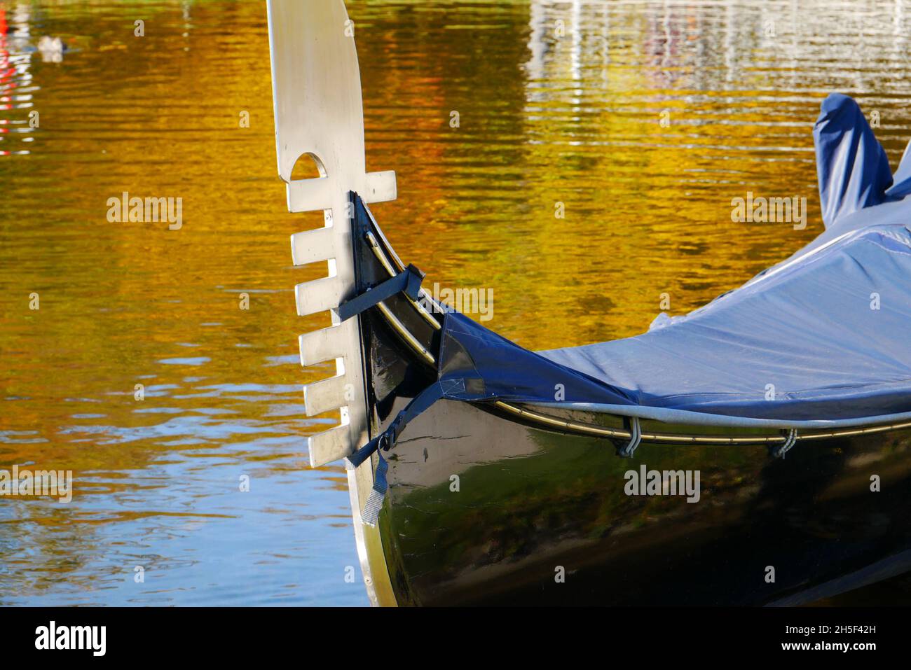 close-up of a venetian gondola with rain cover and metal tail as bow fitting Stock Photo